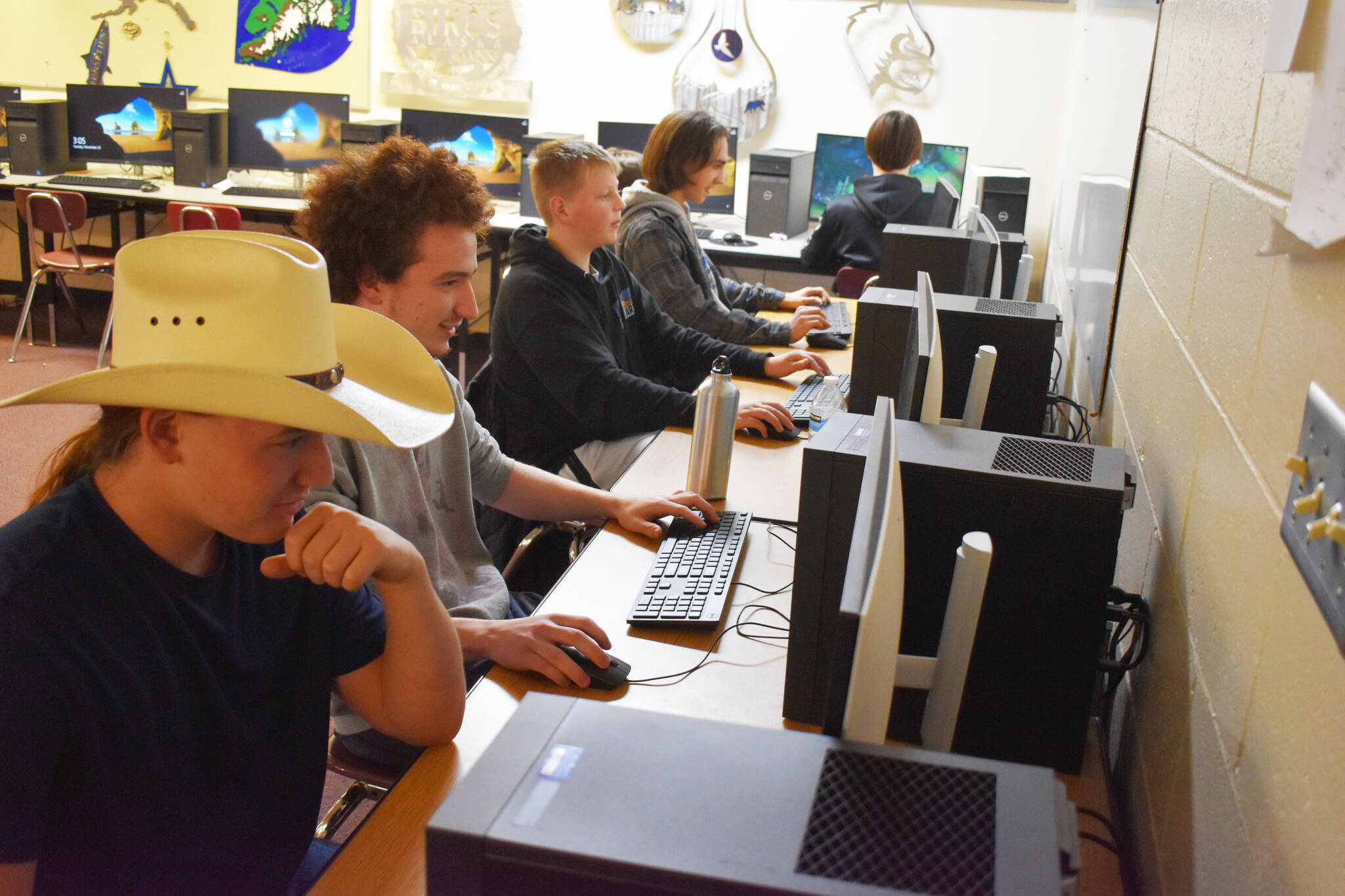 From left, Dain Douthit, Silas Thibodeau, Roman Dunham, Cody Good and Jackson Anding participate in a practice League of Legends match on Tuesday, Nov. 22, 2022 at Kenai Central High School in Kenai, Alaska. (Jake Dye/Peninsula Clarion)