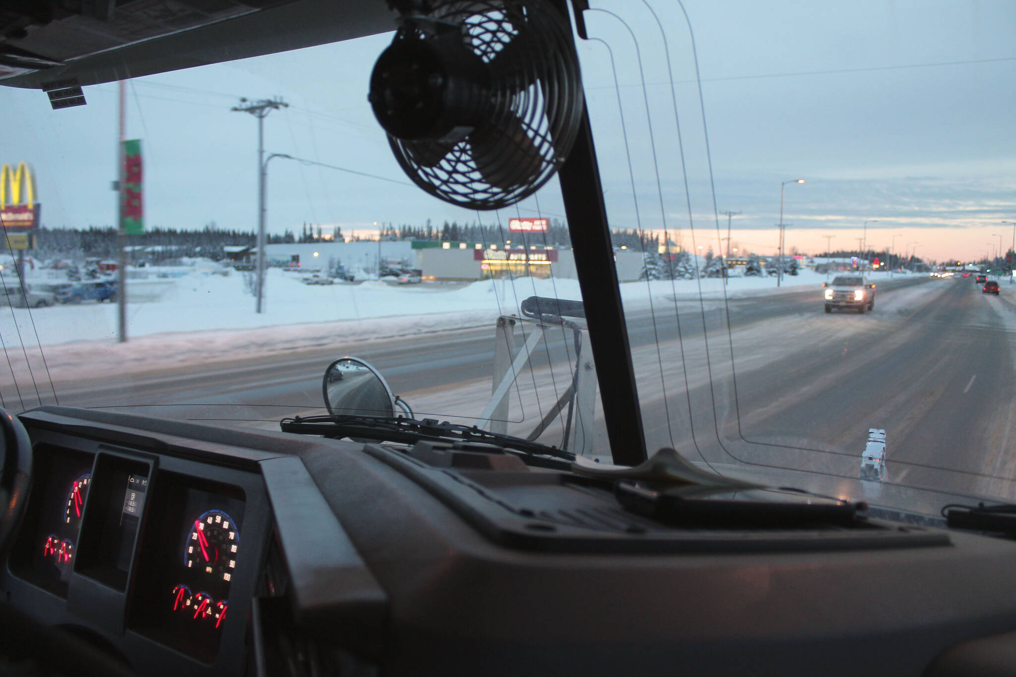 Kenai City Streets foreman Curt Wagoner drives a city sander equipped with a belly blade along the Kenai Spur Highway on Wednesday, Dec. 7, 2022, in Kenai, Alaska. The City of Kenai is not responsible for maintaining state roads. (Ashlyn O’Hara/Peninsula Clarion)