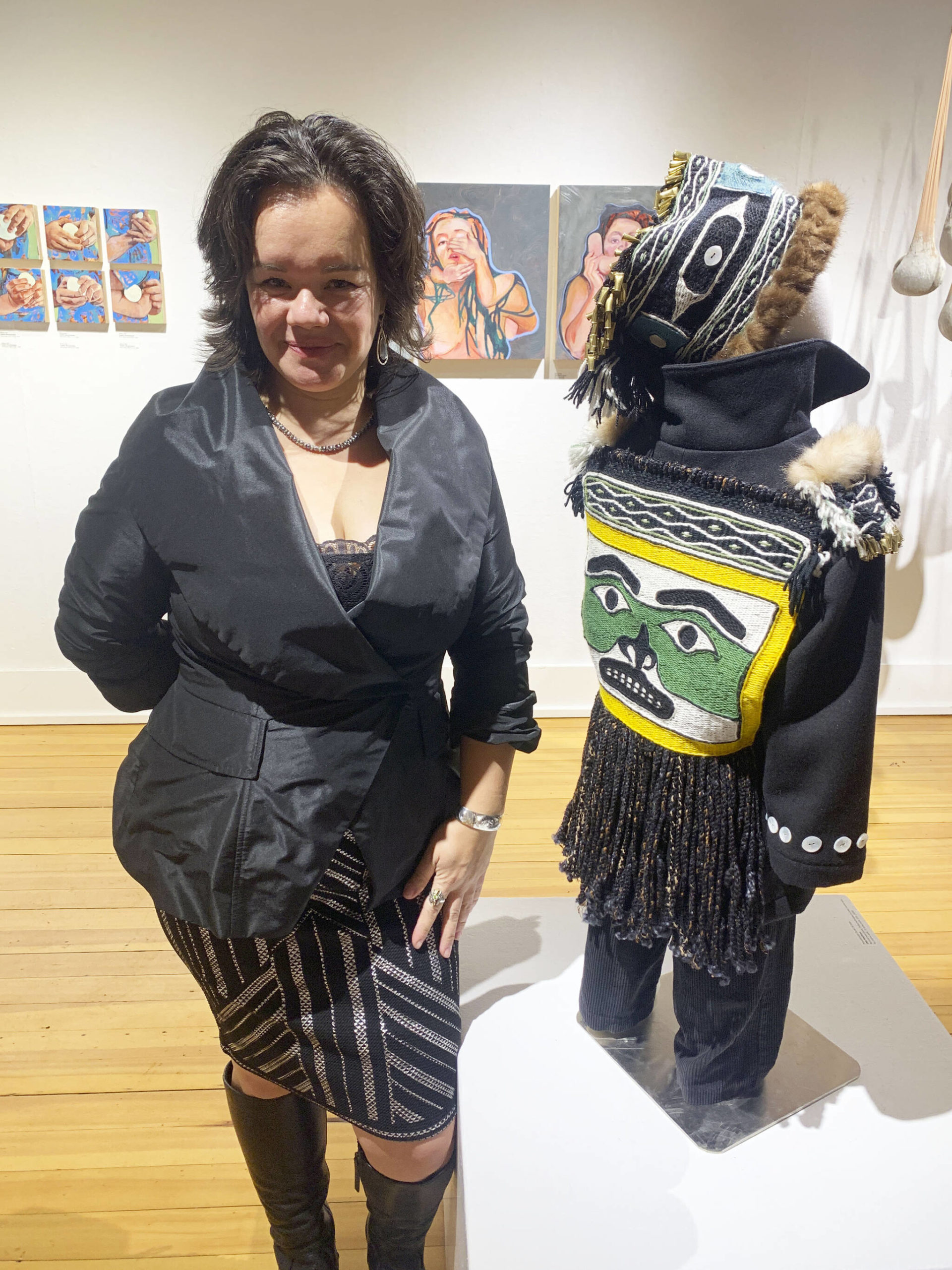 Photo by Christina Whiting 
Juneau artist Lily Wooshkindein Da.Aat poses with her work, Little Watchman, at the opening this month of the exhibit Mother at Bunnell Street Arts Center.