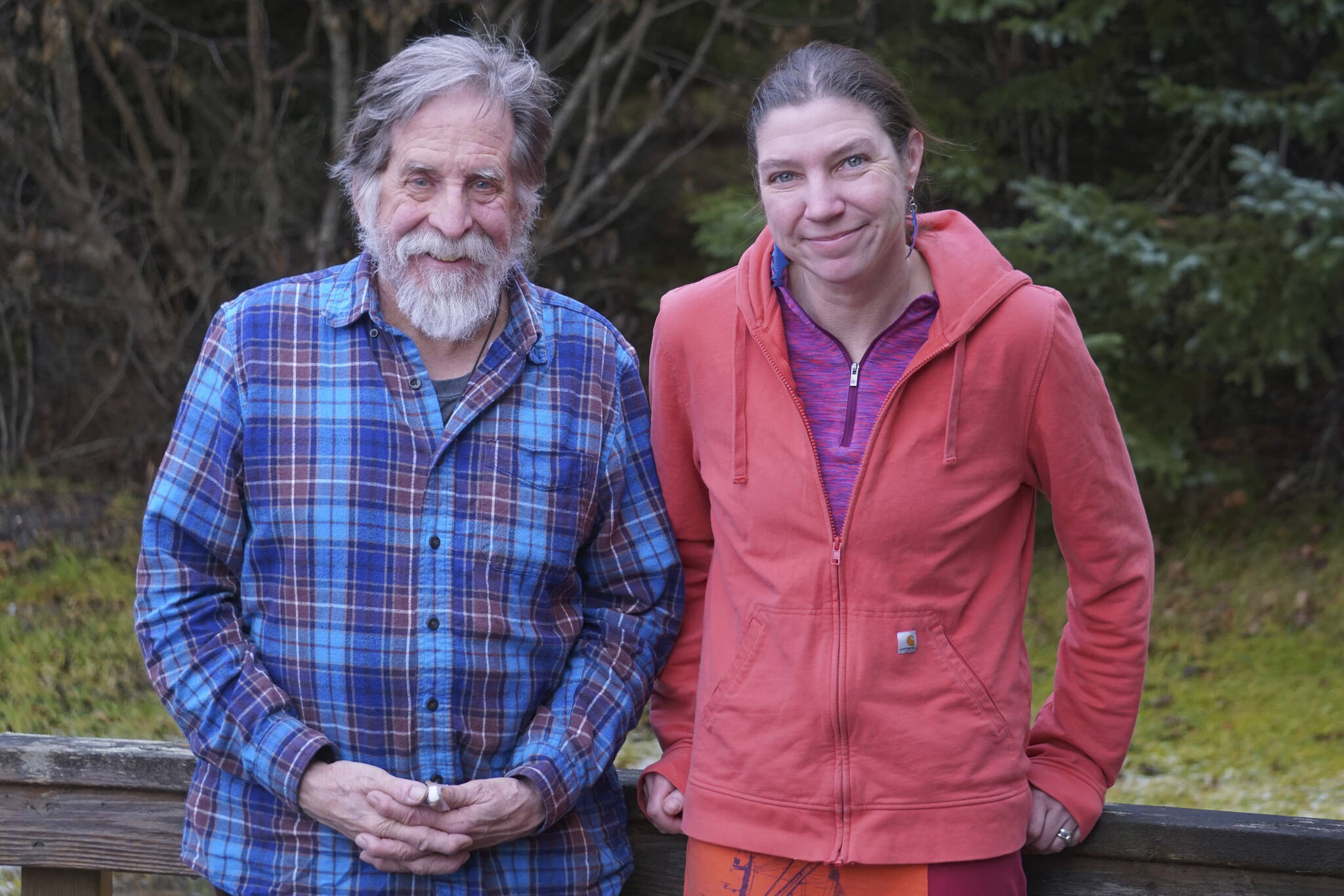 Homer News Editor Michael Armstrong, left, and Senior Reporter Emilie Springer pose for a photo on Tuesday, Dec. 6, 2022, at the newspaper office in Homer, Alaska. (Photo by Charlie Menke/Homer News)