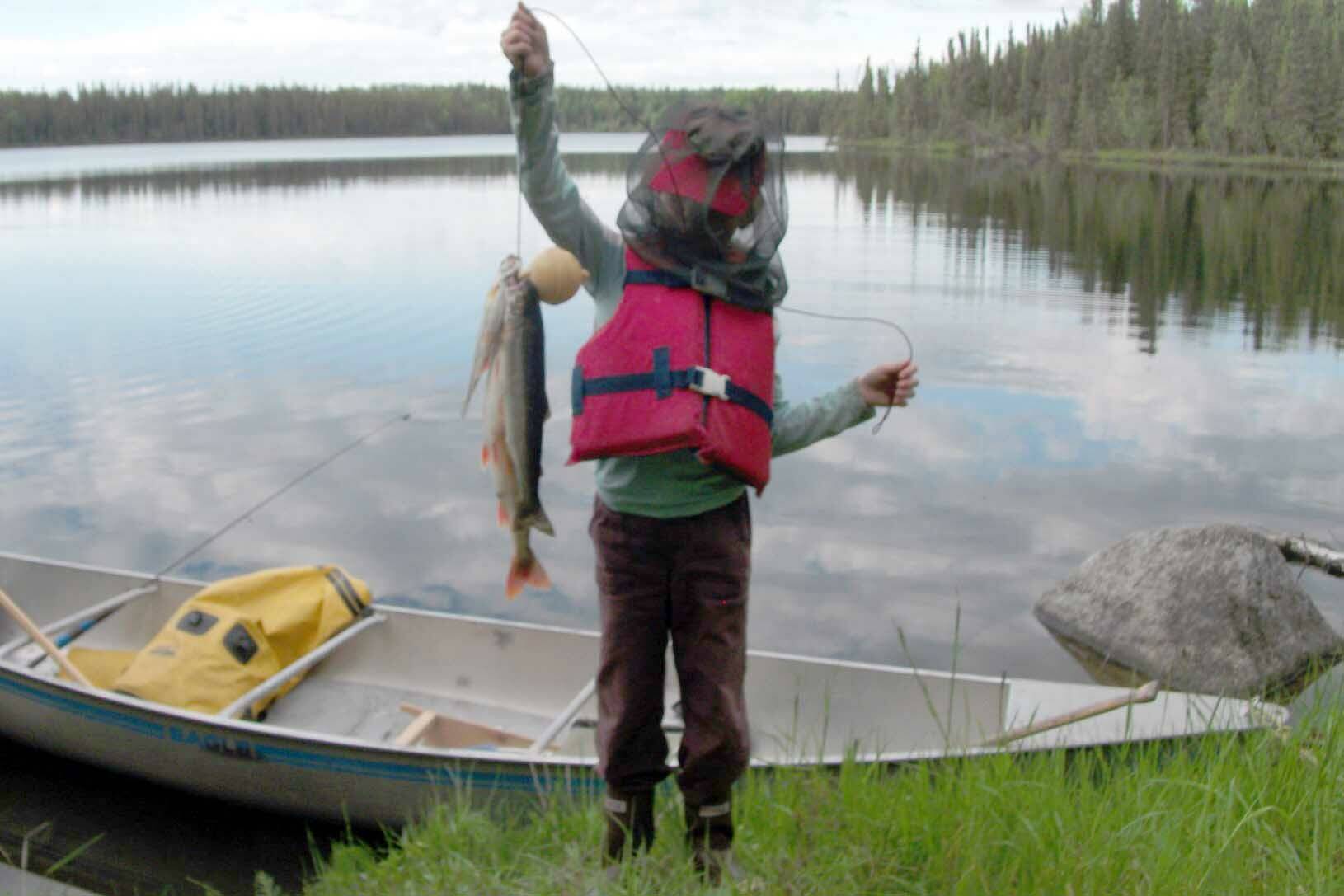 My daughter with our catch of one char (the largest fish) and two trout at Drake Lake, June 17, 2012. (Photo by Matt Bowser)