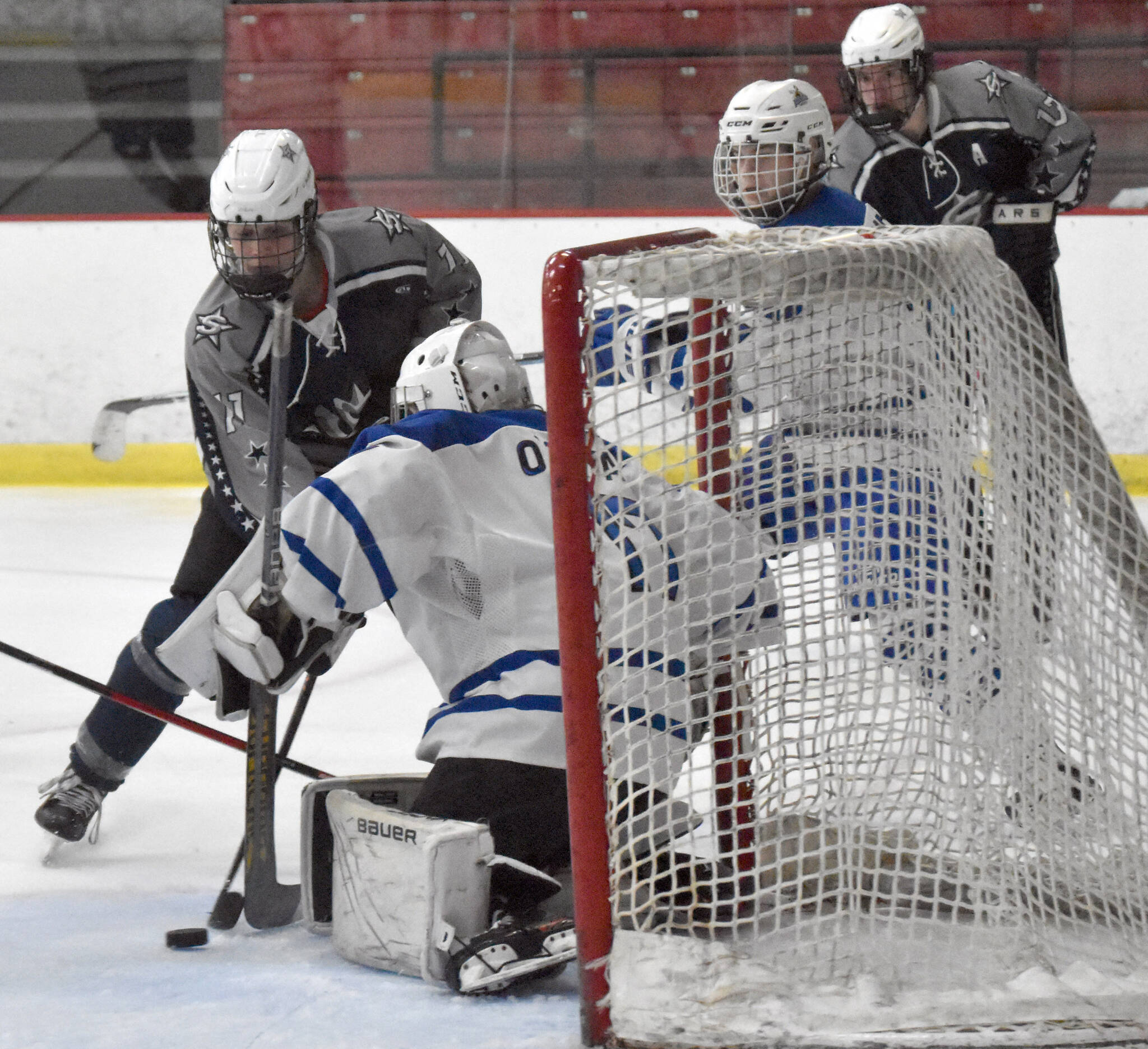 Soldotna’s Boone Theiler pushes a shot wide on Palmer goalie Keagon O’Bryan on Thursday, Dec. 8, 2022, at the Soldotna Regional Sports Complex in Soldotna, Alaska. (Photo by Jeff Helminiak/Peninsula Clarion)