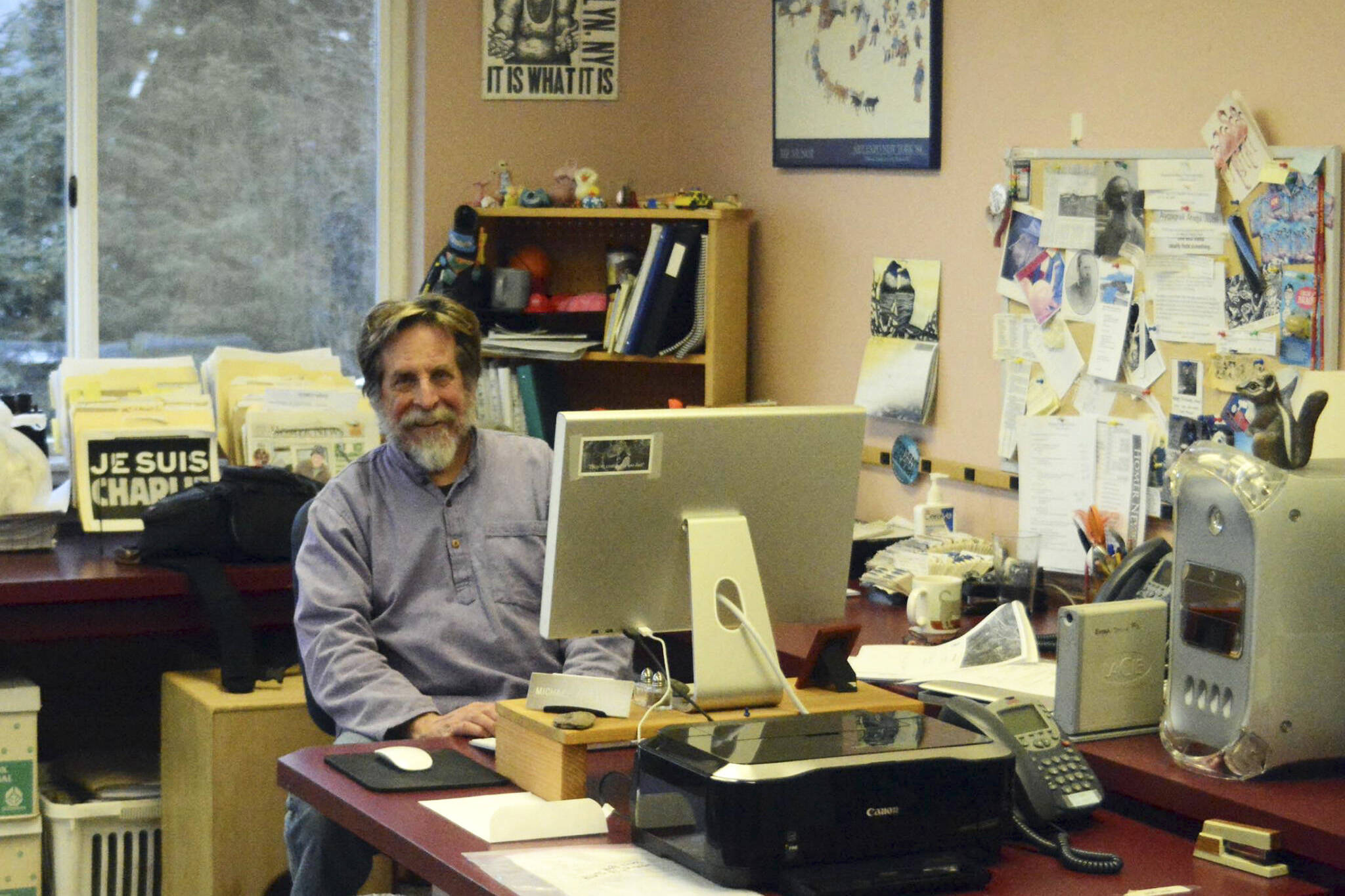 Michael Armstrong poses at his desk in February 2015 at the Homer News in Homer, Alaska. (Photo by McKibben Jackinsky)