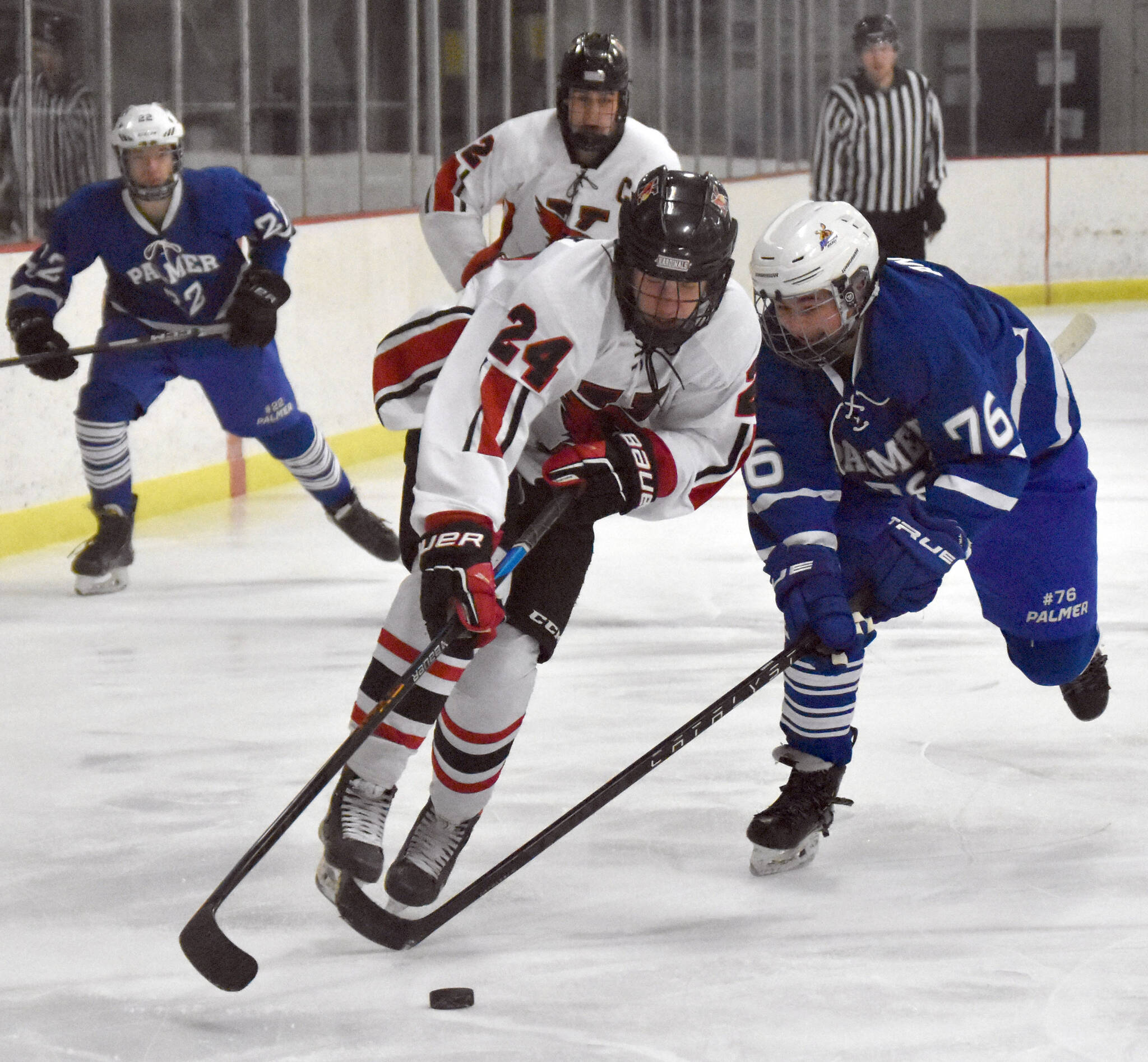 Kenai Central’s Avery Martin tries to get past Palmer’s Zander Anderson on Friday, Dec. 9, 2022, at the Kenai Multi-Purpose Facility in Kenai, Alaska. (Photo by Jeff Helminiak/Peninsula Clarion)