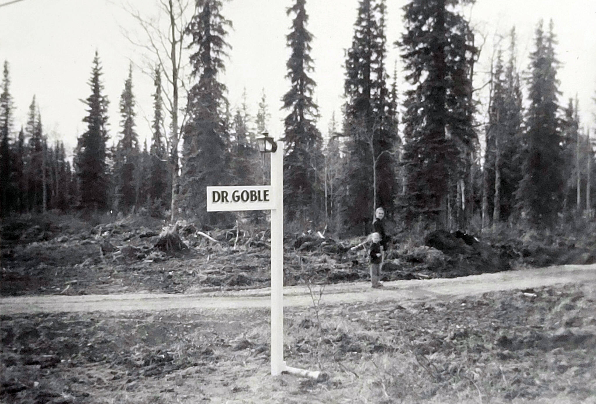 Near Dr. Goble’s clinic, Marian and Grace Goble walk down an early version of McCollum Drive in Kenai, circa 1959-60. (Photo courtesy of Ben and Marian Goble)