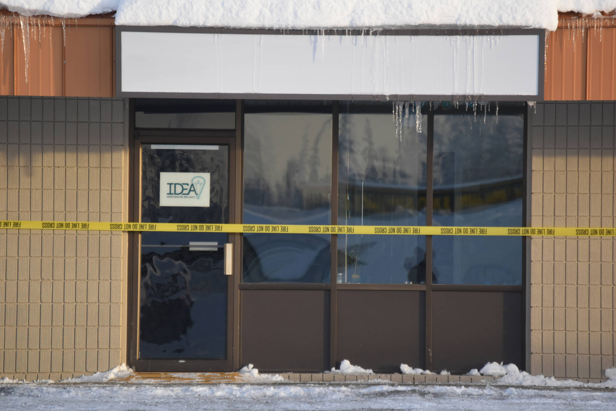 IDEA Homeschool offices are closed with caution tape hours after a roof collapse forced staff to evacuate on Friday, Dec. 16, 2022, in Soldotna, Alaska. Other businesses within the Copper Center were also closed as a result of the collapse. (Jake Dye/Peninsula Clarion)