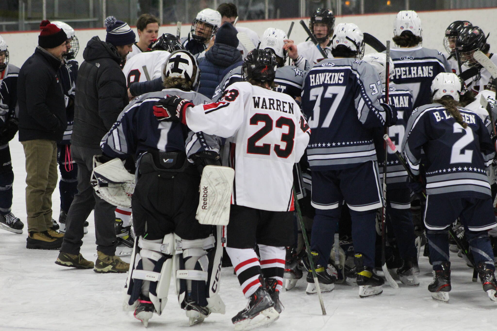 The SoHi and Kenai Central hockey teams meet at center ice to pray for the Clyde family after the game on Thursday, Dec. 16, 2022, at the Kenai Multi-Purpose Facility in Kenai, Alaska. Tanner Clyde, a SoHi goalie, lost his father to a fatal car collision earlier this week. (Photo courtesy Rylie Thompson)