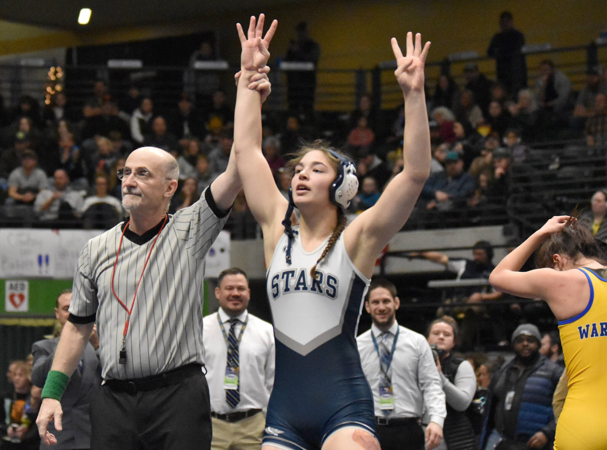 Soldotna’s Trinity Donovan celebrates becoming the third girls in Alaska history to win four state wrestling titles Saturday, Dec. 18, 2022, at the state wrestling tournament at the Alaska Airlines Center in Anchorage, Alaska. (Photo by Jeff Helminiak/Peninsula Clarion)