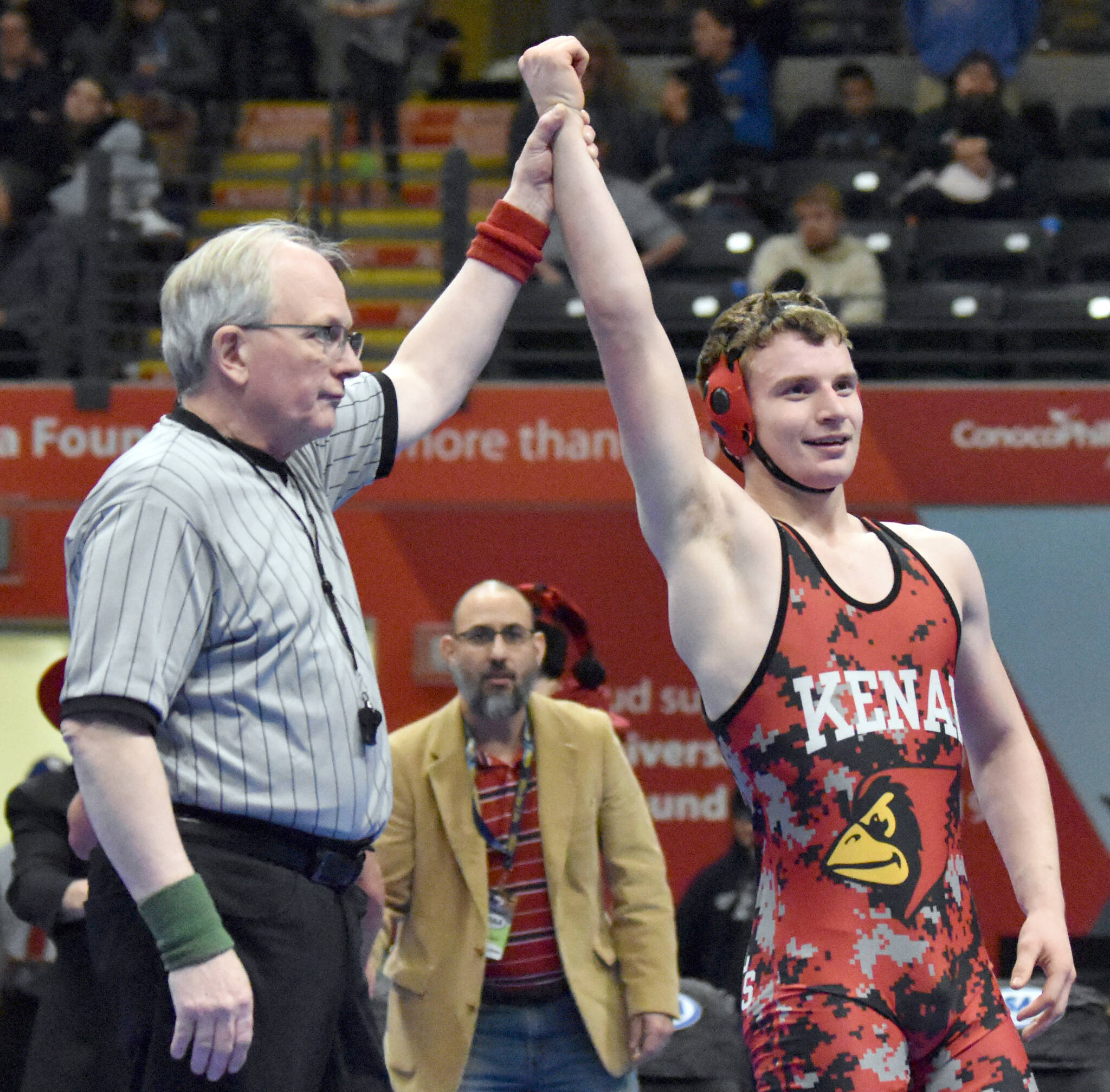 Kenai Central’s Andrew Gaethle celebrates winning a Division II state title at 152 pounds as Kardinals head coach Jason Chavarria looks on Saturday, Dec. 18, 2022, at the state wrestling tournament at the Alaska Airlines Center in Anchorage, Alaska. (Photo by Jeff Helminiak/Peninsula Clarion)