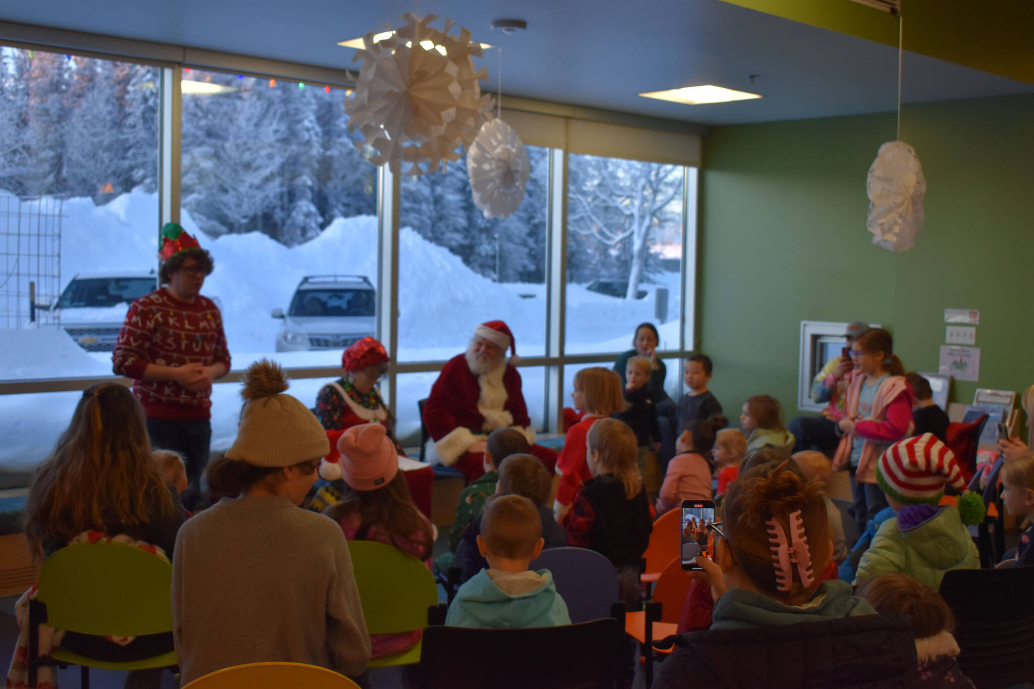 Children fill the Kid Zone during Story Time with Mrs. Claus at the Kenai Community Library in Kenai, Alaska, on Monday, Dec. 19, 2022. (Jake Dye/Peninsula Clarion)