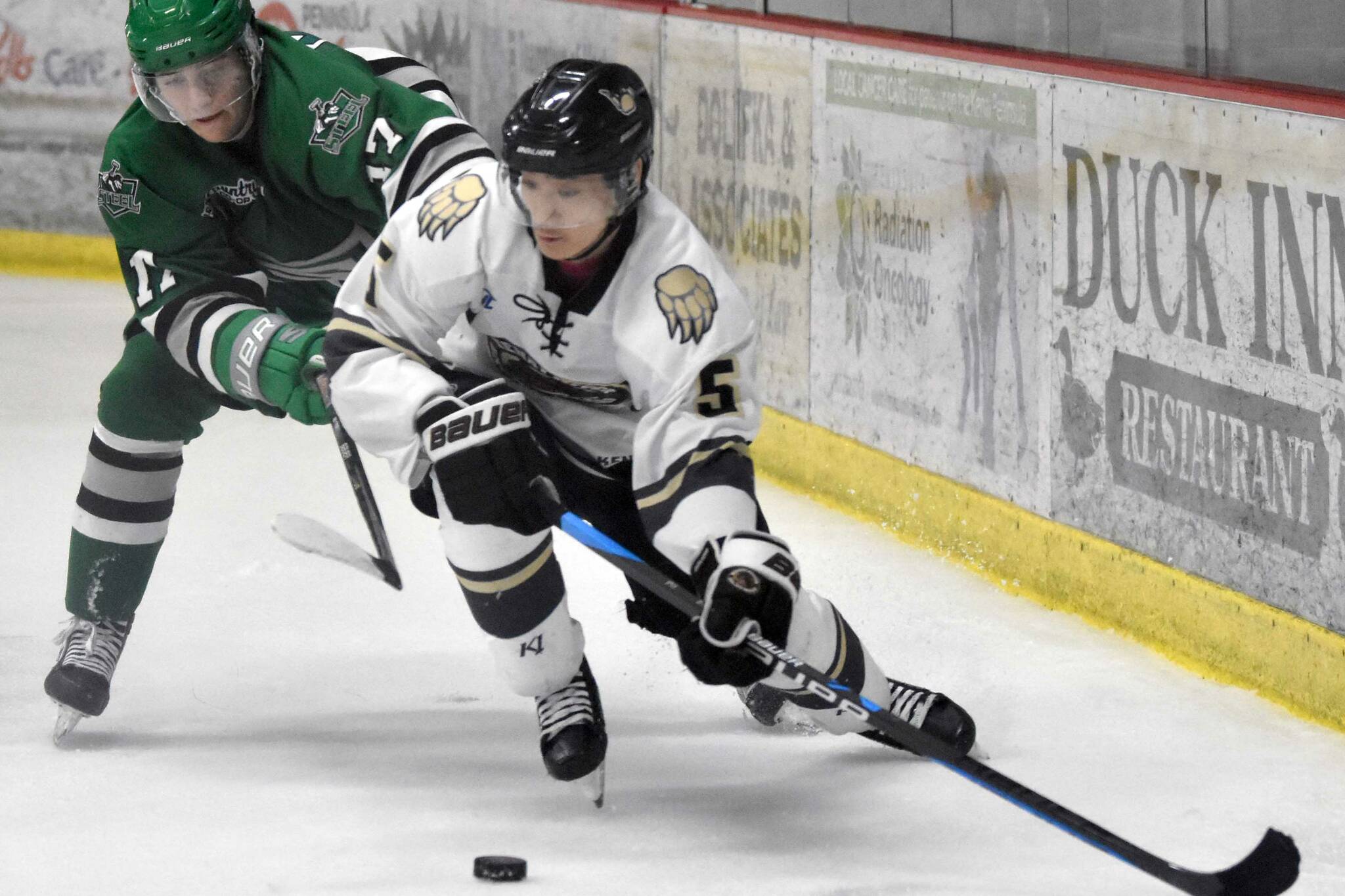 Kenai River Brown Bears forward Kotaro Tsutsumi protects the puck from Chippewa (Wisconsin) Steel forward Peyton Platter on Saturday, Oct. 29, 2022, at the Soldotna Regional Sports Complex in Soldotna, Alaska. (Photo by Jeff Helminiak/Peninsula Clarion)