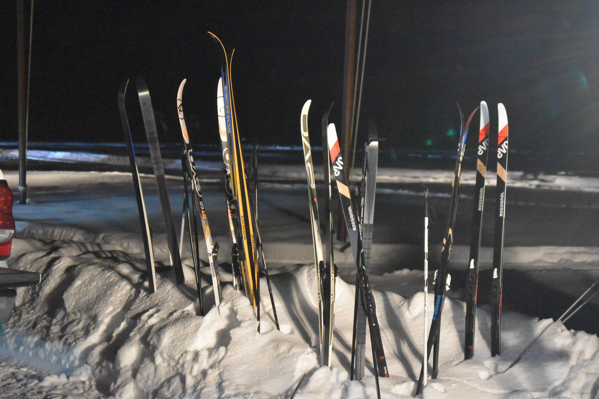 Skis poke out of the snow minutes before the start of StarLight StarBright: A Winter Solstice Ski Event on Wednesday, Dec. 21, 2022 at the Kenai Golf Course in Kenai, Alaska.