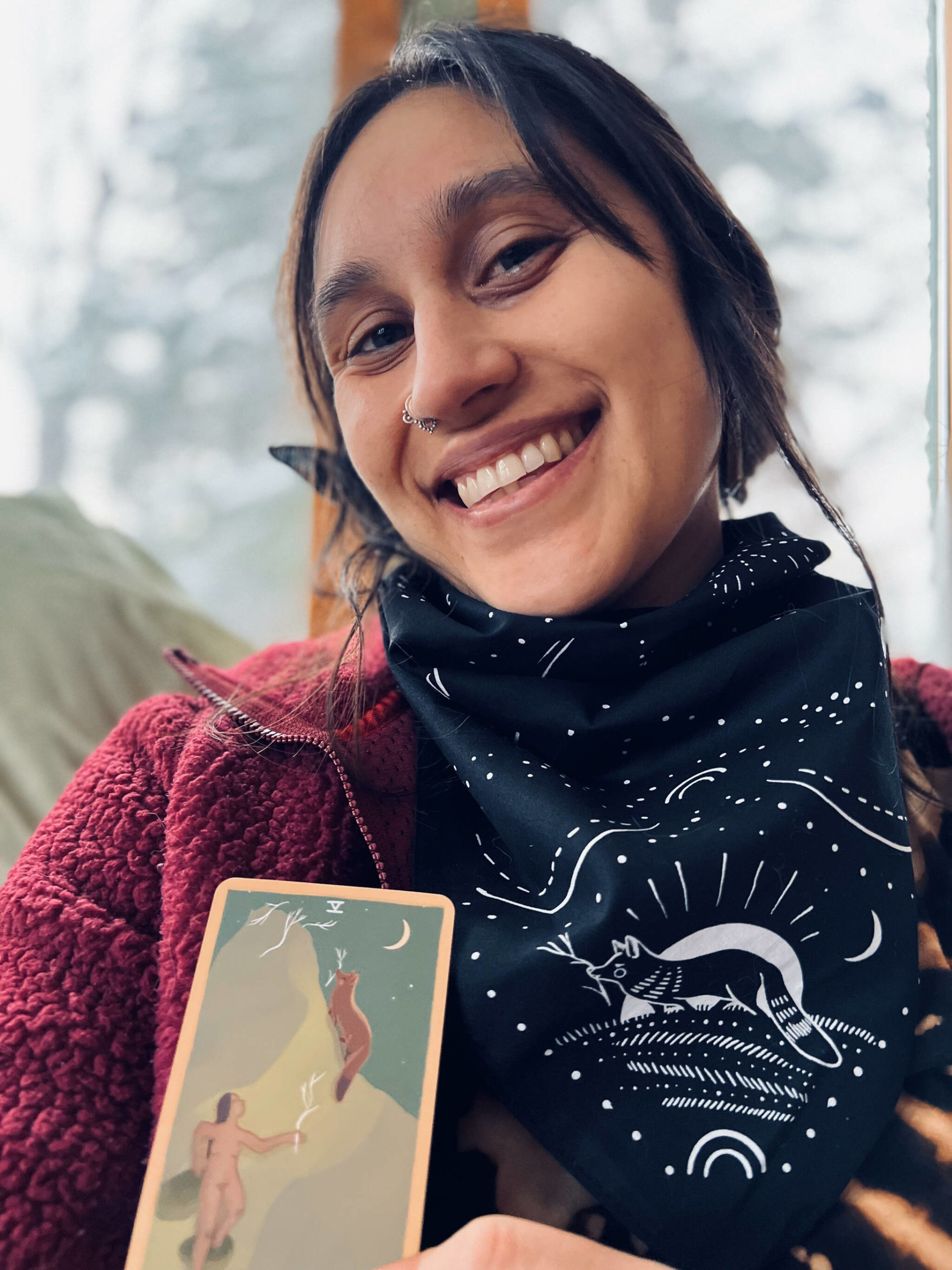 Mariza Ryce Aparicio-Tovar poses with a card from “The Gentle Tarot” deck. (Photo provided by Mariza Ryce-Tovar)