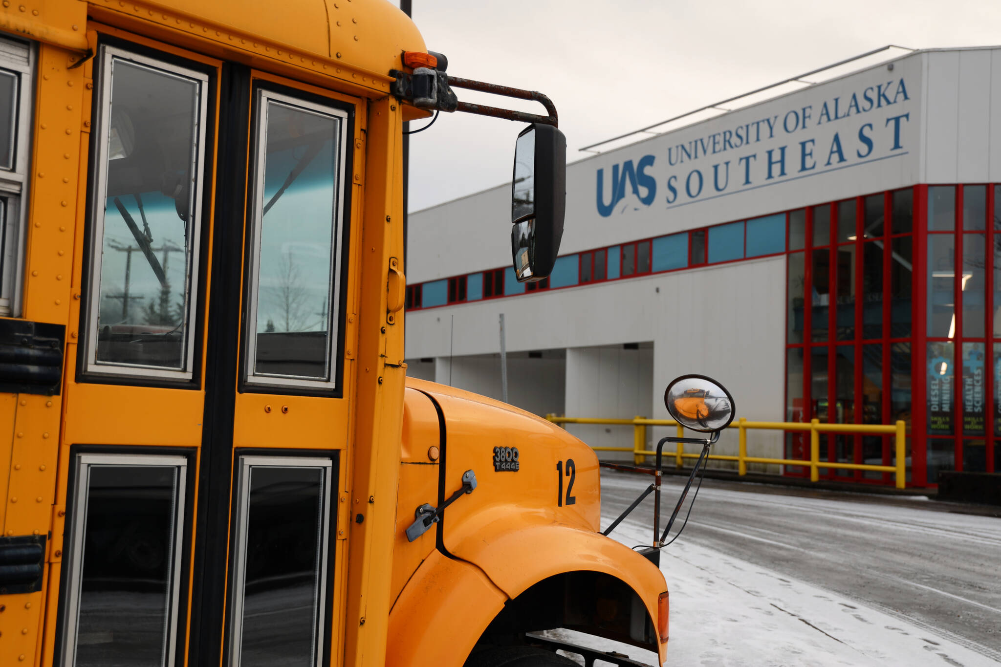 A school bus sits in the parking lot of the University of Southeast Alaska Tech Center downtown. In the fall of 2024, a new commercial driver’s license education training program is expected to be offered at the campus. (Clarise Larson / Juneau Empire)