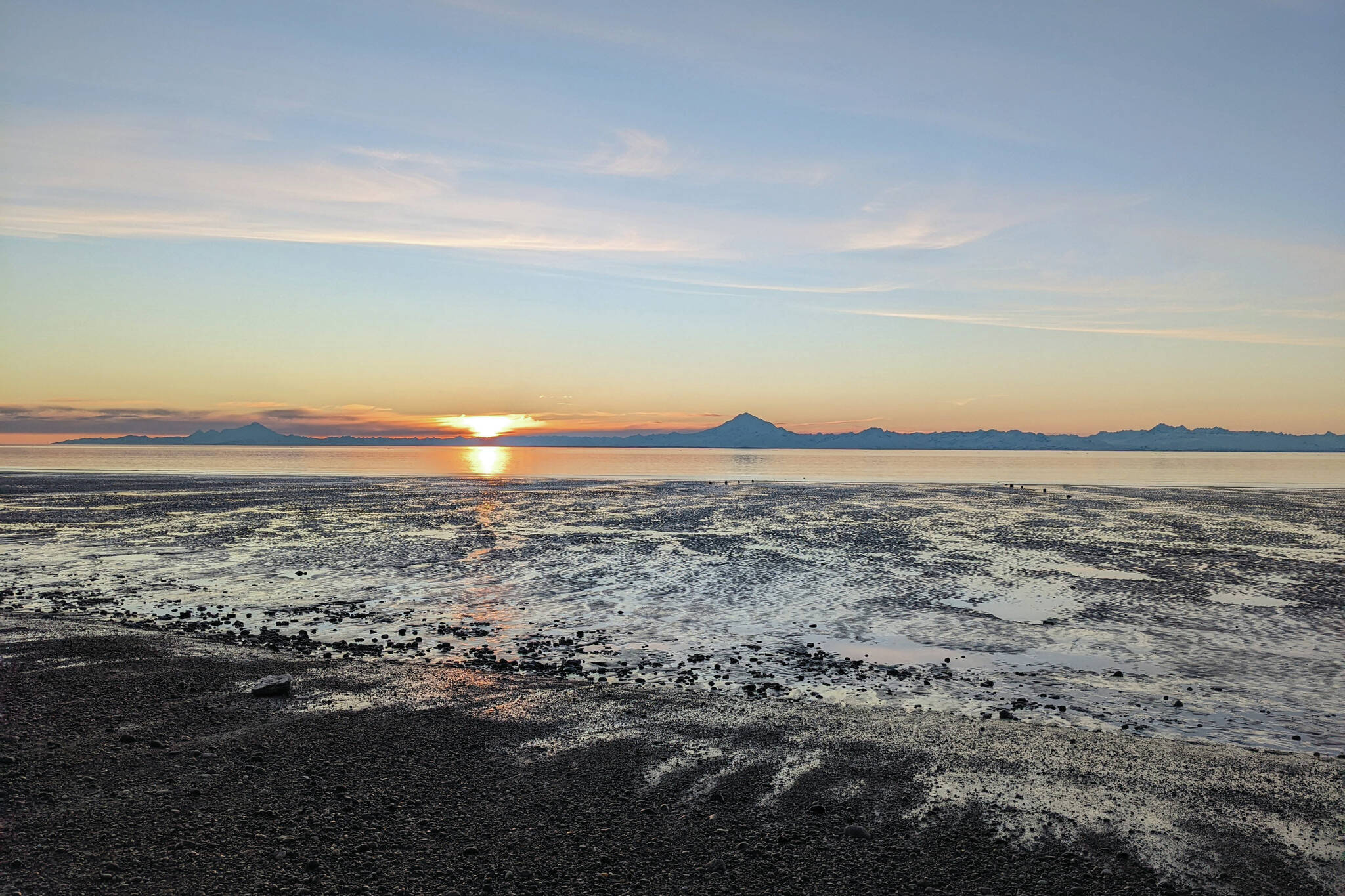 Mounts Iliamna and Redoubt are seen at sunset on Feb. 22, 2022, in Kenai, Alaska. (Photo by Erin Thompson/Peninsula Clarion)