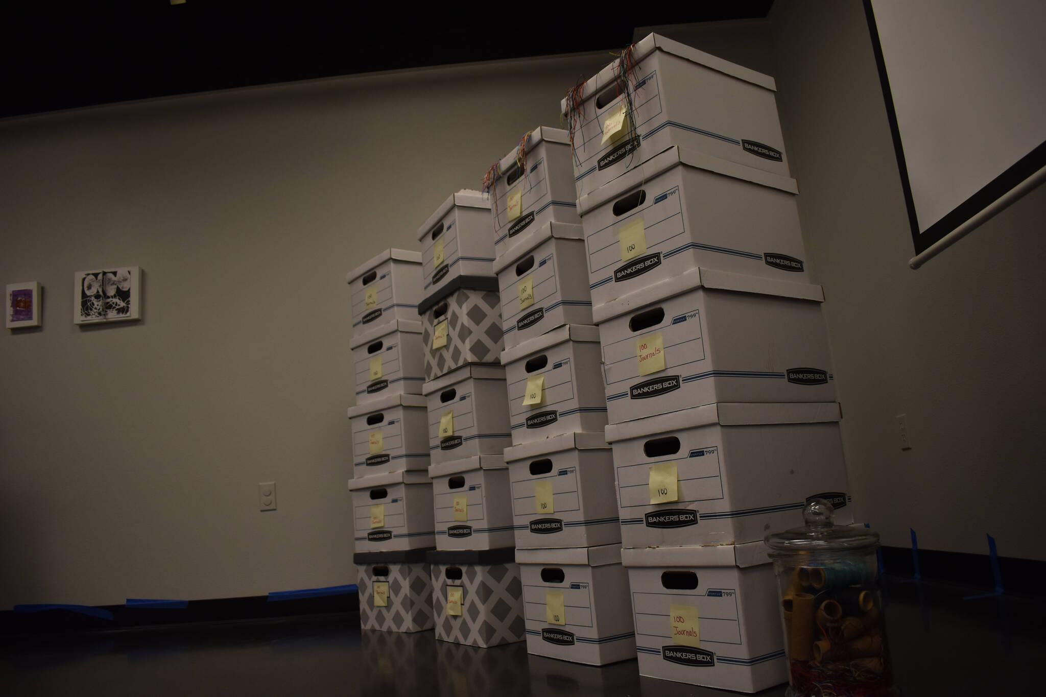 Boxes which were once filled with 2000 journals sit empty on Tuesday, Jan. 3, 2023, ahead of the opening of Diane Dunn’s “2000 Journals: Filling the Void” at the Kenai Art Center in Kenai, Alaska. (Jake Dye/Peninsula Clarion)