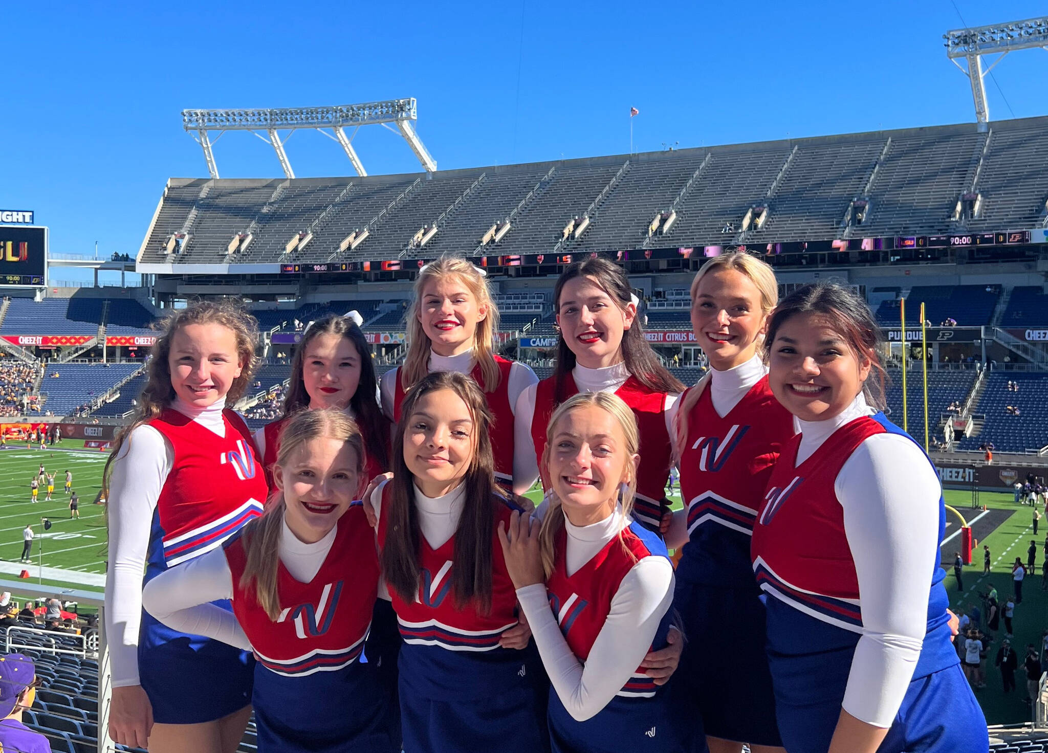 Members of the Kenai Central High School cheerleading team (back row, left to right): Kaitlyn Taylor, Sylvia McGraw, Malena Grieme, Maya Montague, Cali Holmes and Genesis Trevino; (front row, left to right): Makenzie Harden, Ella Romero and Brooklyn Reed stand for a photo at the Cheez-It Citrus Bowl on Monday, Jan. 1, 2023, at Camping World Stadium in Orlando, Florida. (Photo courtesy Brianna Force)