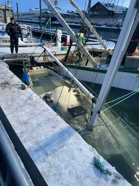 The submerged vessel breaks the surface of the water in haul-out process, Dec. 28, 2022. (Photo provided by Harbor crew)