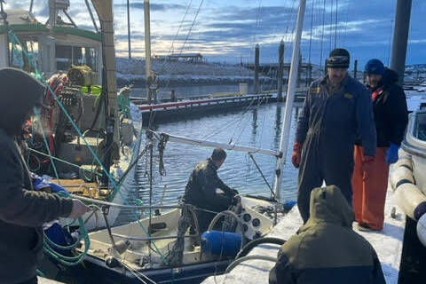 Matt Clarke and Homer Harbor crew assess vessel sunk vessel in Homer Harbor on Dec. 27, 2022. (Photo provided by Harbor crew)
