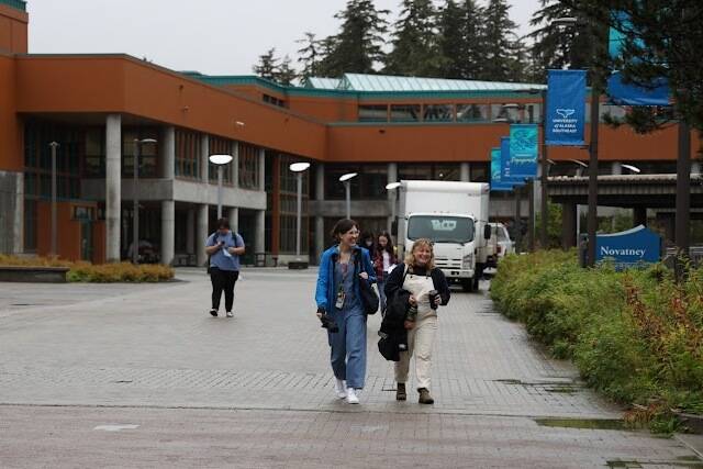 Students smile as they walk to their classes for the first day of fall semester at the University of Alaska Southeast. The University of Alaska is set to receive 360,000 acres of federal land within the next four years, set in motion by a clause included in the recently passed $1.7 trillion federal spending bill. (Clarise Larson / Juneau Empire)