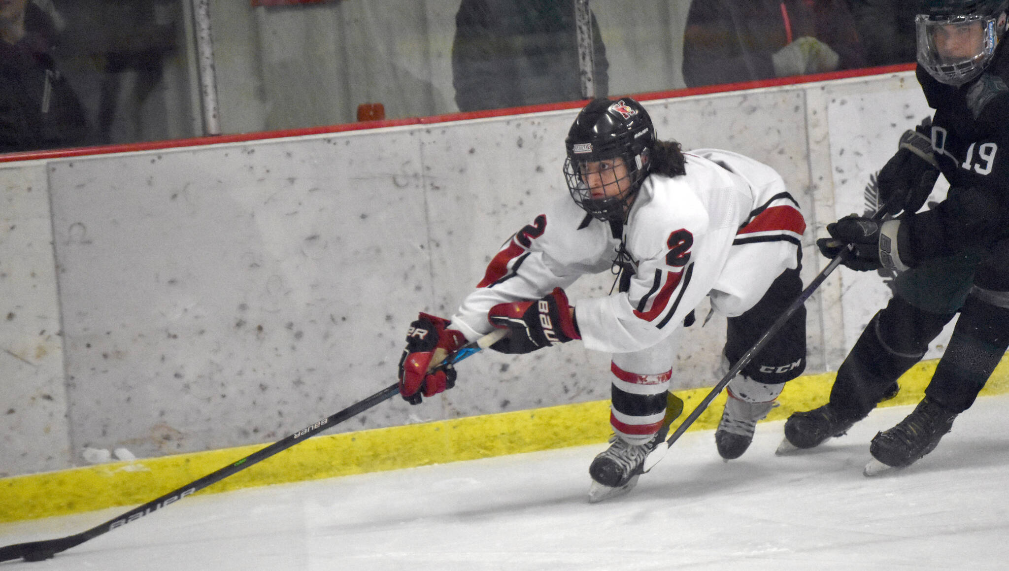 Kenai Central’s Logan Mese keeps the puck from Colony’s Carsen Lantto on Thursday, Jan. 5, 2023, at the Kenai Multi-Purpose Facility in Kenai, Alaska. (Photo by Jeff Helminiak/Peninsula Clarion)