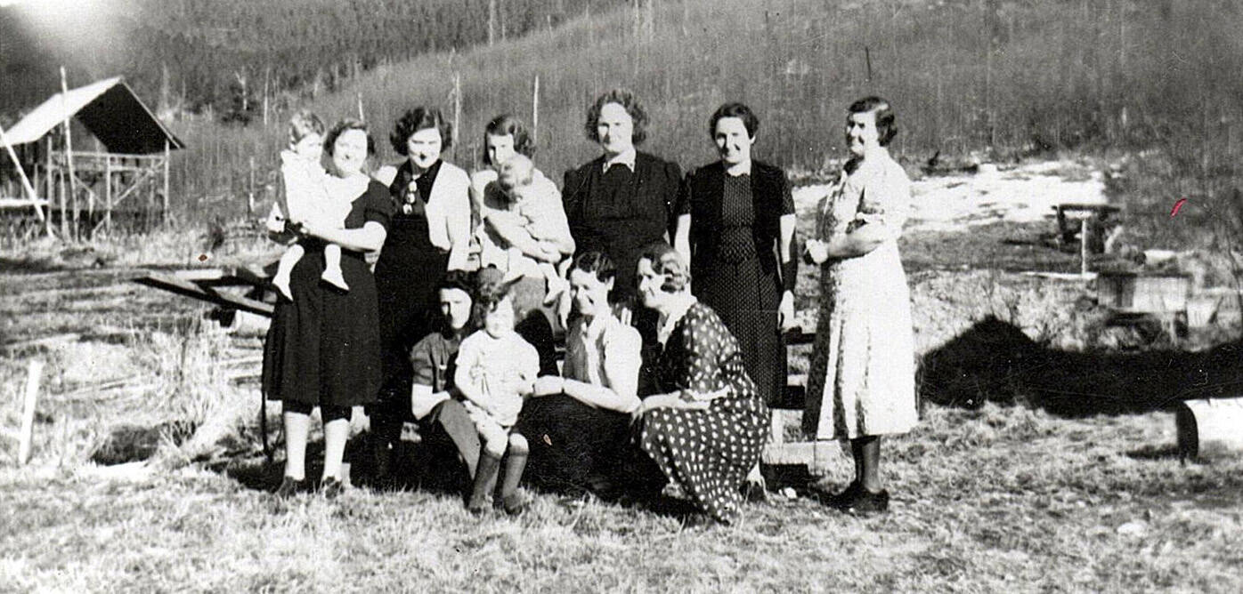 Photo 210.029.055, from the Clark Collection, courtesy of Hope and Sunrise Historical and Mining Museum 
Members of the Hope Homemakers Club pose for a circa 1940 group shot. Emma Clark, holding daughter Carla, is standing third from the left in the back row; Emma’s older daughter Berdie is in front of her, sitting on the lap of an unidentified woman who is seated in the front row.