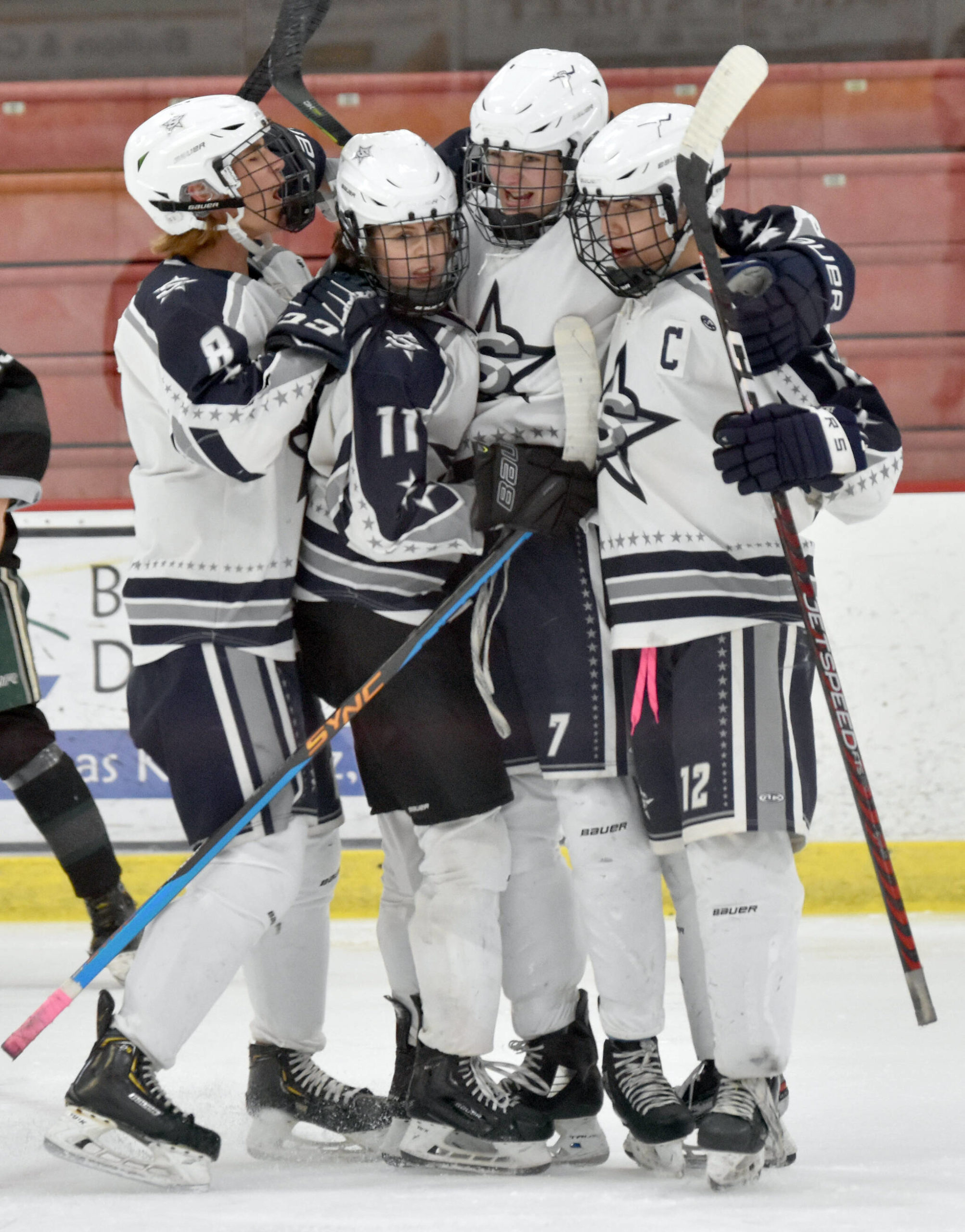Soldotna’s Jace Appelhans (7) celebrates his first-period goal against Colony with Dawson Lockwood, Boone Theiler and Aiden Burcham on Saturday, Jan. 7, 2023, at the Soldotna Regional Sports Complex in Soldotna, Alaska. (Photo by Jeff Helminiak/Peninsula Clarion)
