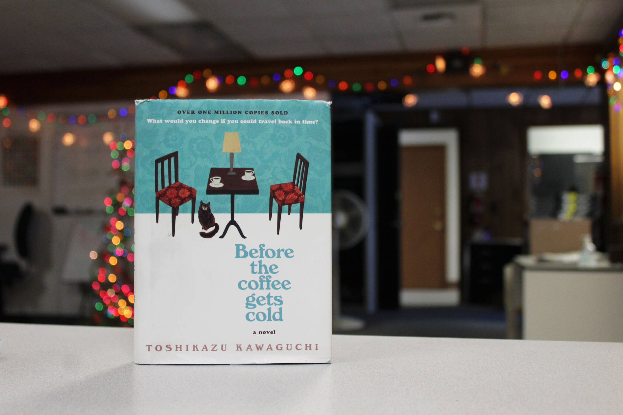 A copy of “Before the Coffee Gets Cold” stands on a desk in the Peninsula Clarion office on Wednesday, Jan. 11, 2023, in Kenai, Alaska. (Ashlyn O’Hara/Peninsula Clarion)