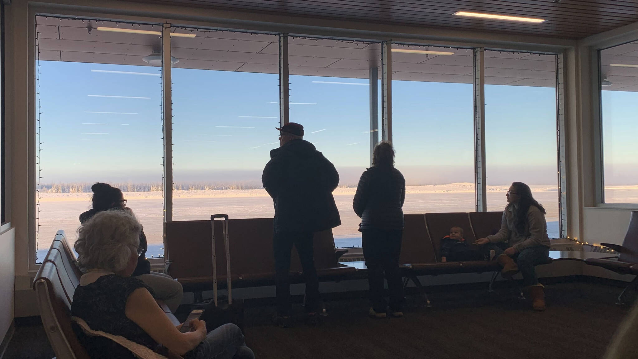 People wait for planes at Kenai Municipal Airport on Monday, Dec. 19, 2022 in Kenai, Alaska. (Ashlyn O'Hara/Peninsula Clarion)