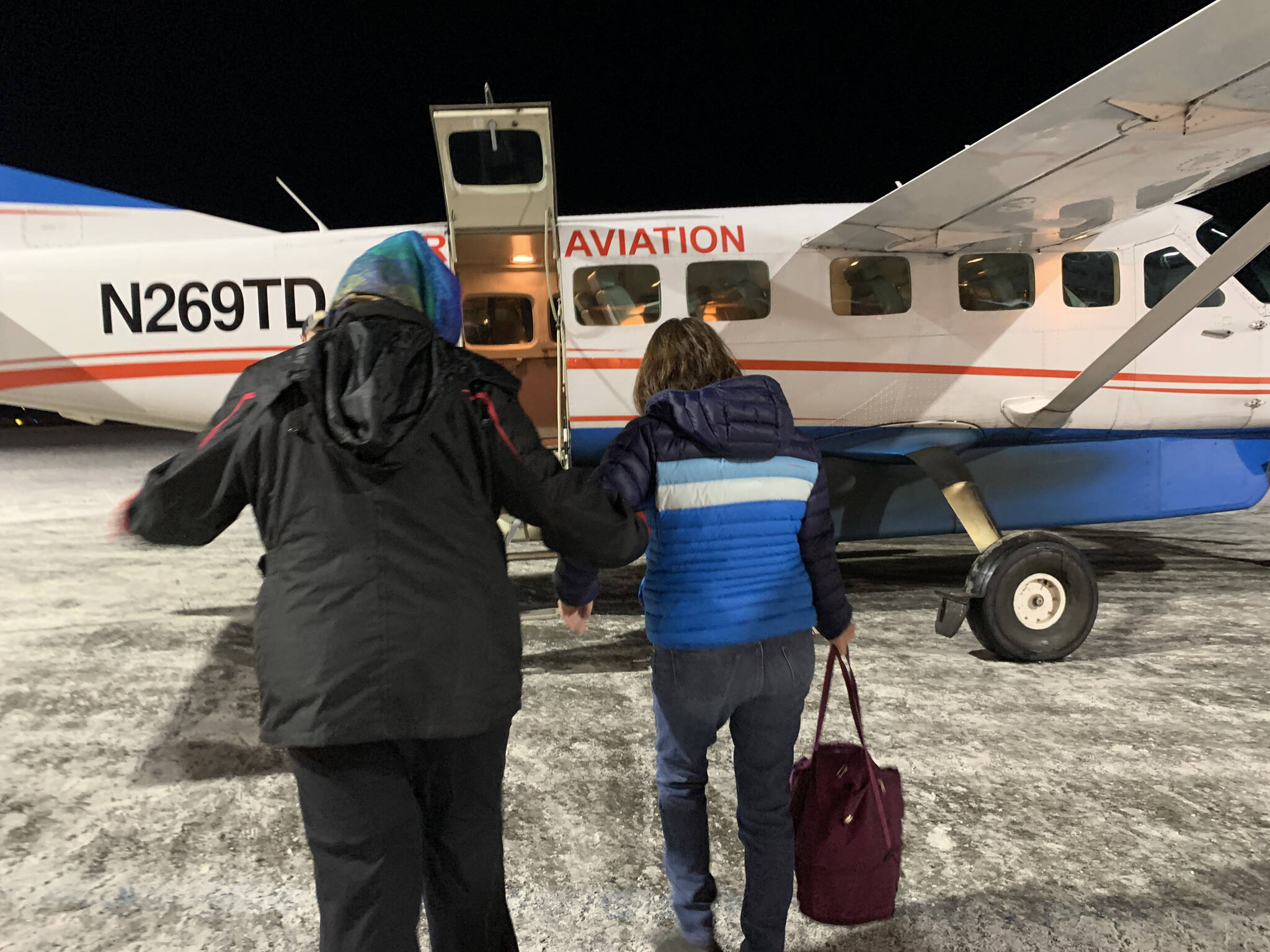 A passenger boards a Kenai-bound Grant Aviation flight at Ted Stevens Anchorage International Airport on Friday, Jan. 6 in Anchorage, Alaska. (Ashlyn O'Hara/Peninsula Clarion)