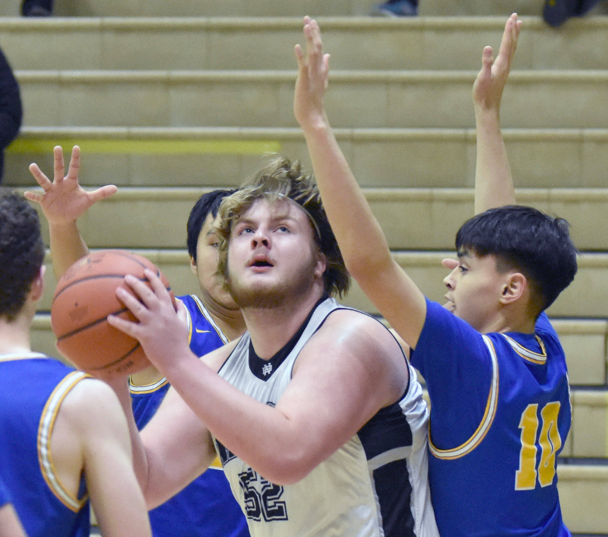 Nikiski’s Drew Handley posts up on Kotzebue’s Bron Baldwin on Saturday, Jan. 14, 2023, at the 34th Annual Rus Hitchcock Nikiski Tip Off Tournament at Nikiski High School in Nikiski, Alaska. (Photo by Jeff Helminiak/Peninsula Clarion)