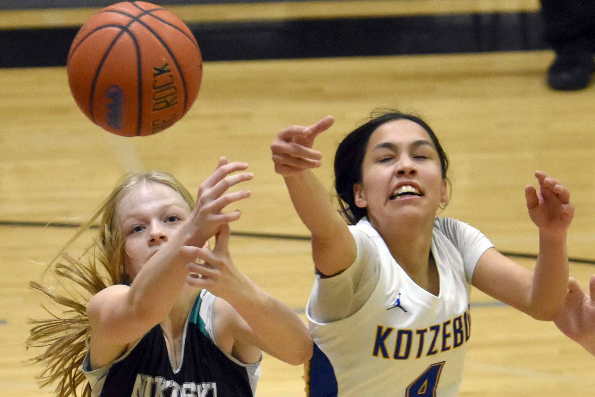 Nikiski's Avery White and Kotzebue's Zaina McConnell battle for the ball Saturday, Jan. 14, 2023, at the 34th Annual Rus Hitchcock Nikiski Tip Off Tournament at Nikiski High School in Nikiski, Alaska. (Photo by Jeff Helminiak/Peninsula Clarion)