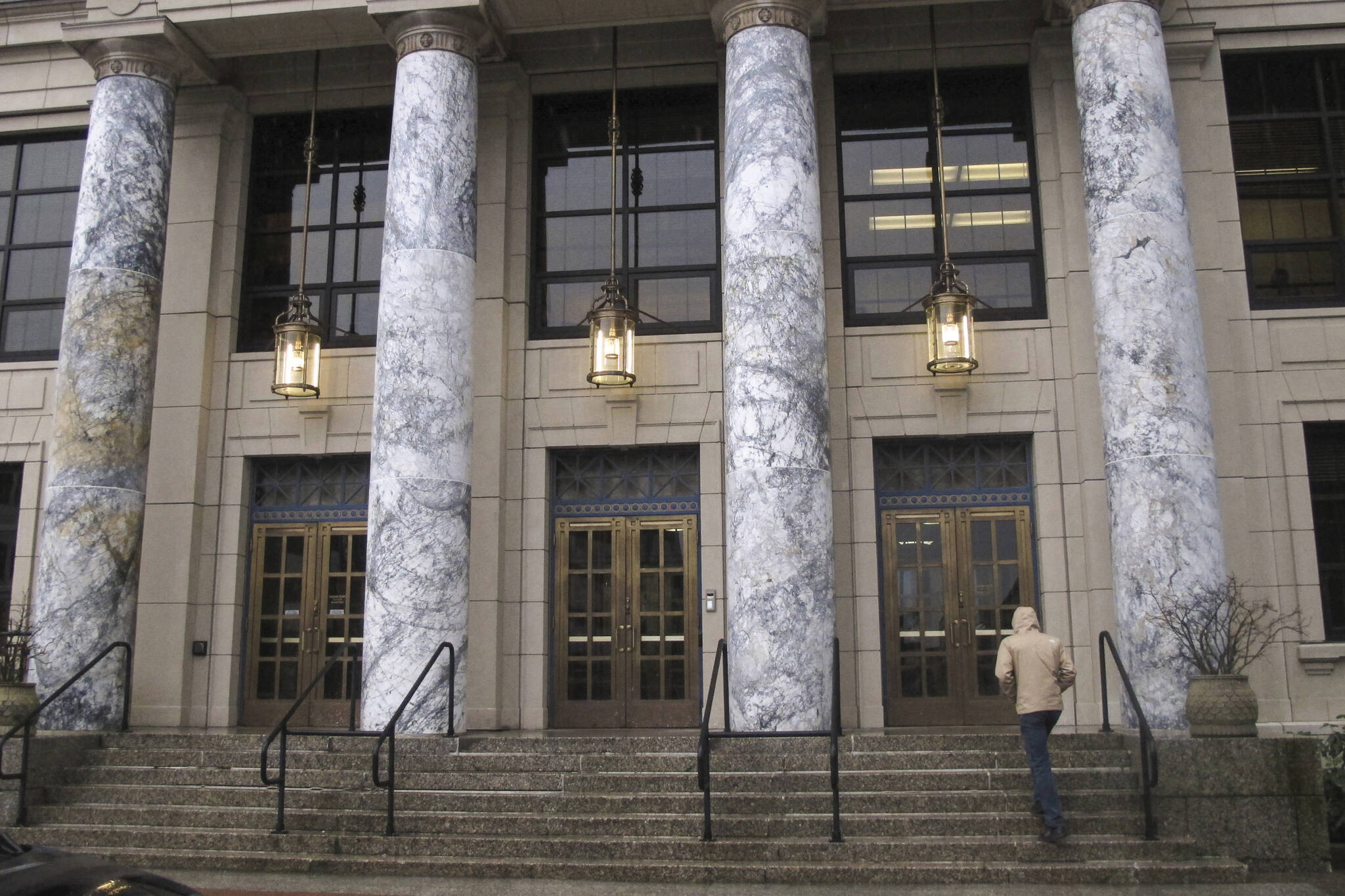 A person walks up the steps of the Alaska Capitol on Monday, Jan. 16, 2023, in Juneau, Alaska. The new legislative session begins on Tuesday, Jan. 17. (AP Photo/Becky Bohrer)