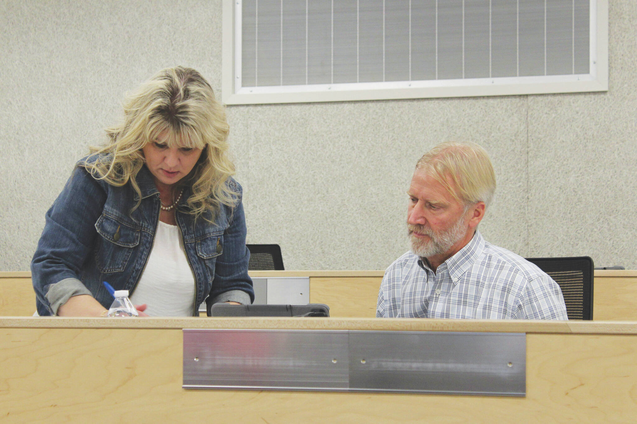 Acting Kenai Peninsula Borough Clerk Michele Turner helps newly sworn-in assembly member Peter Ribbens set up assembly materials on Tuesday, Jan. 17, 2023, in Soldotna, Alaska. (Ashlyn O'Hara/Peninsula Clarion)