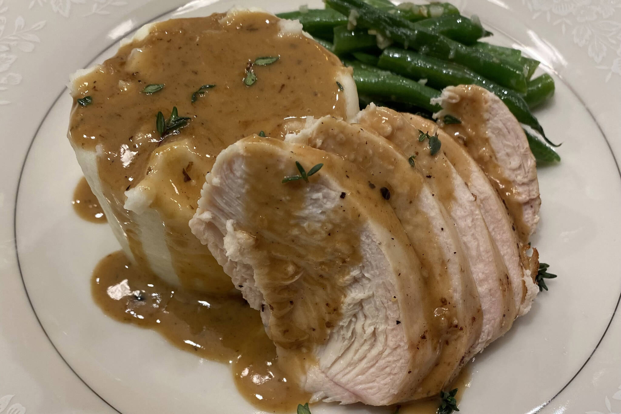 Mashed potatoes are served with chicken breast, green beans and pan sauce. (Photo by Tressa Dale/Peninsula Clarion)