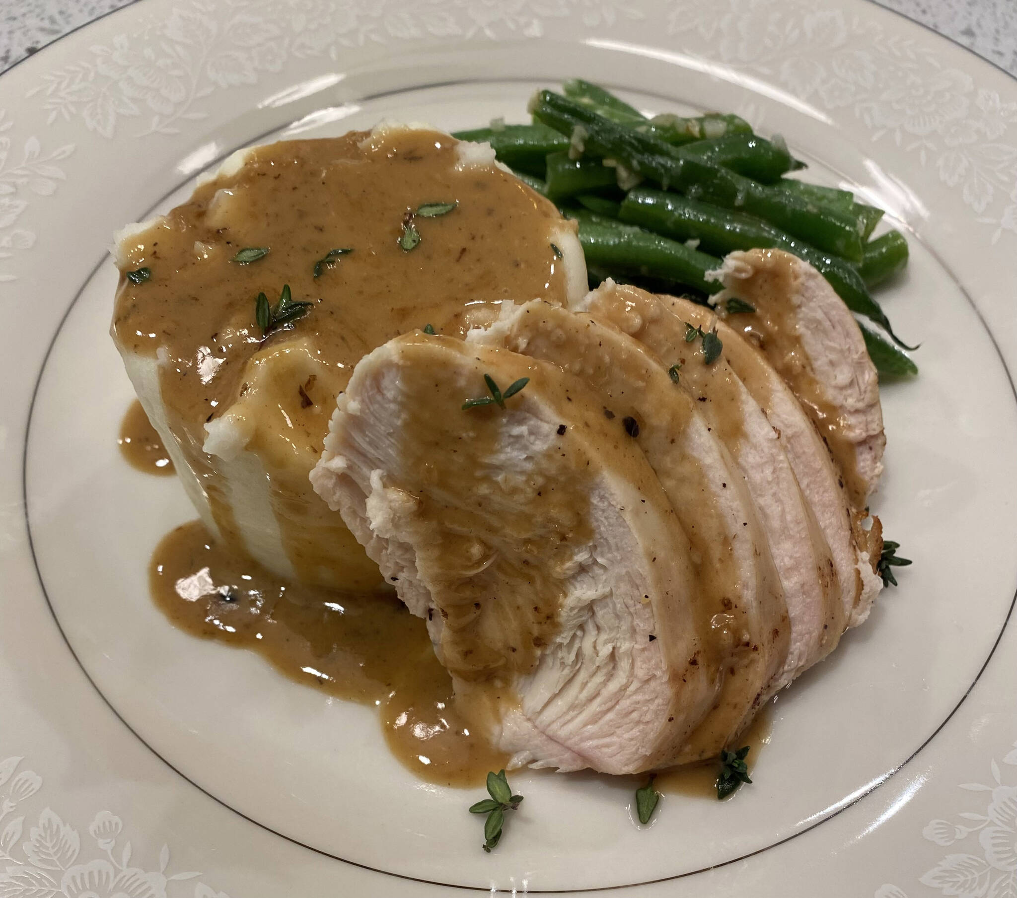 Mashed potatoes are served with chicken breast, green beans and pan sauce. (Photo by Tressa Dale/Peninsula Clarion)