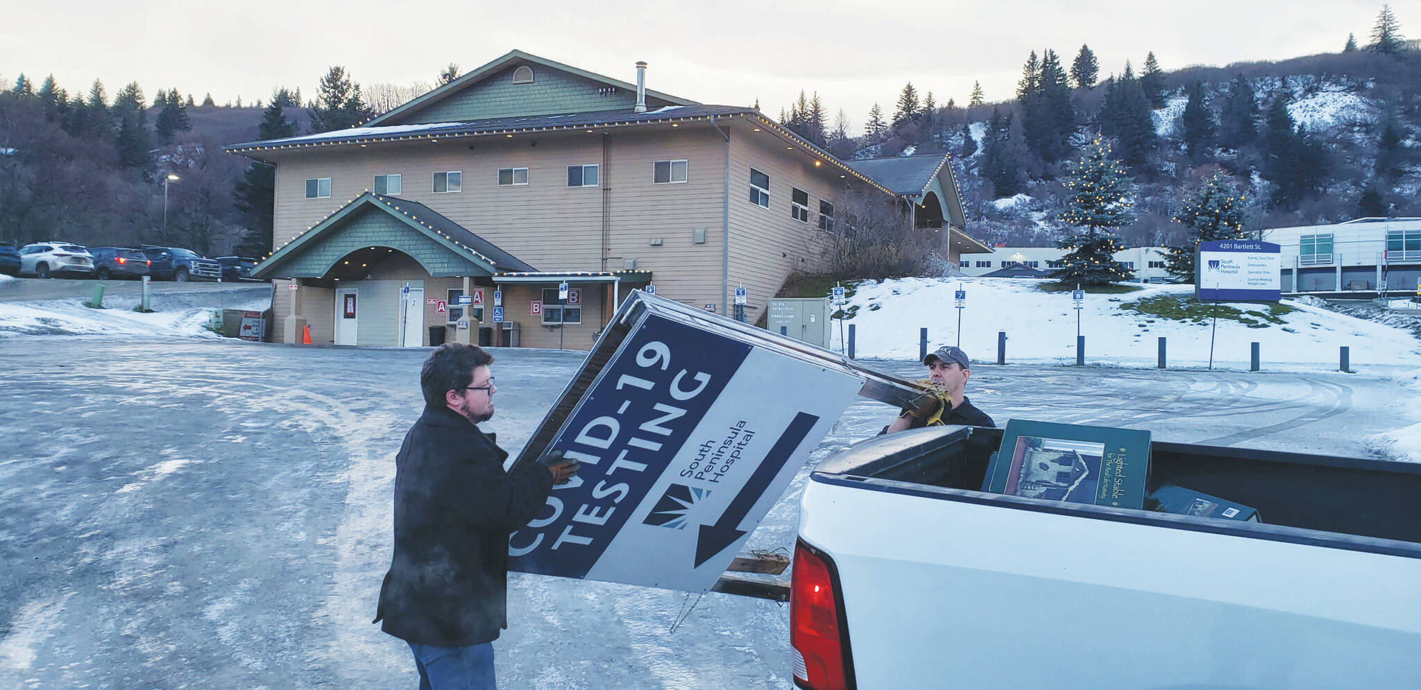 South Peninsula Hospital employees remove COVID-19 testing signs from South Peninsula Hospital test site Friday Jan. 13, 2023. (Photo from Derotha Ferraro/South Peninsula Hospital)