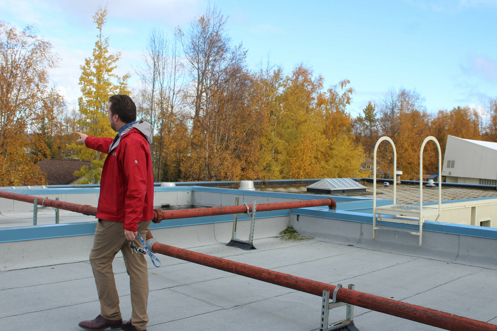 Soldotna Elementary School Principal Dr. Austin Stevenson walks amid natural gas pipes anchored to the outside of school on Friday, Sept. 30, 2022 in Soldotna, Alaska. (Ashlyn O’Hara/Peninsula Clarion)