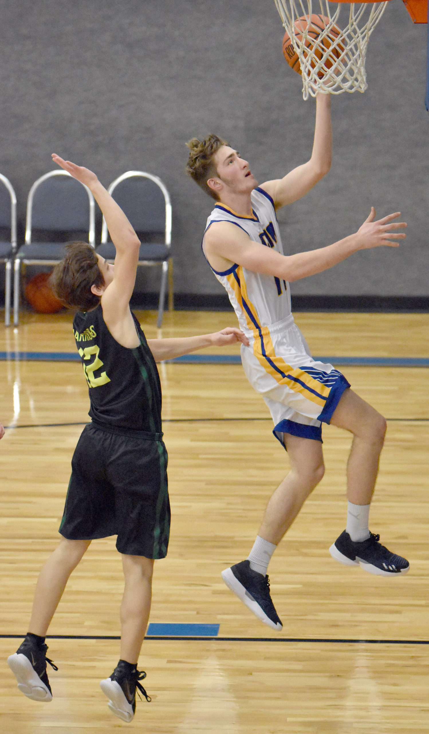 Cook Inlet Academy’s Abraham Henderson drives to the basket against Birchwood Christian on Saturday, Jan. 21, 2023, at Cook Inlet Academy near Soldotna, Alaska. (Photo by Jeff Helminiak/Peninsula Clarion)