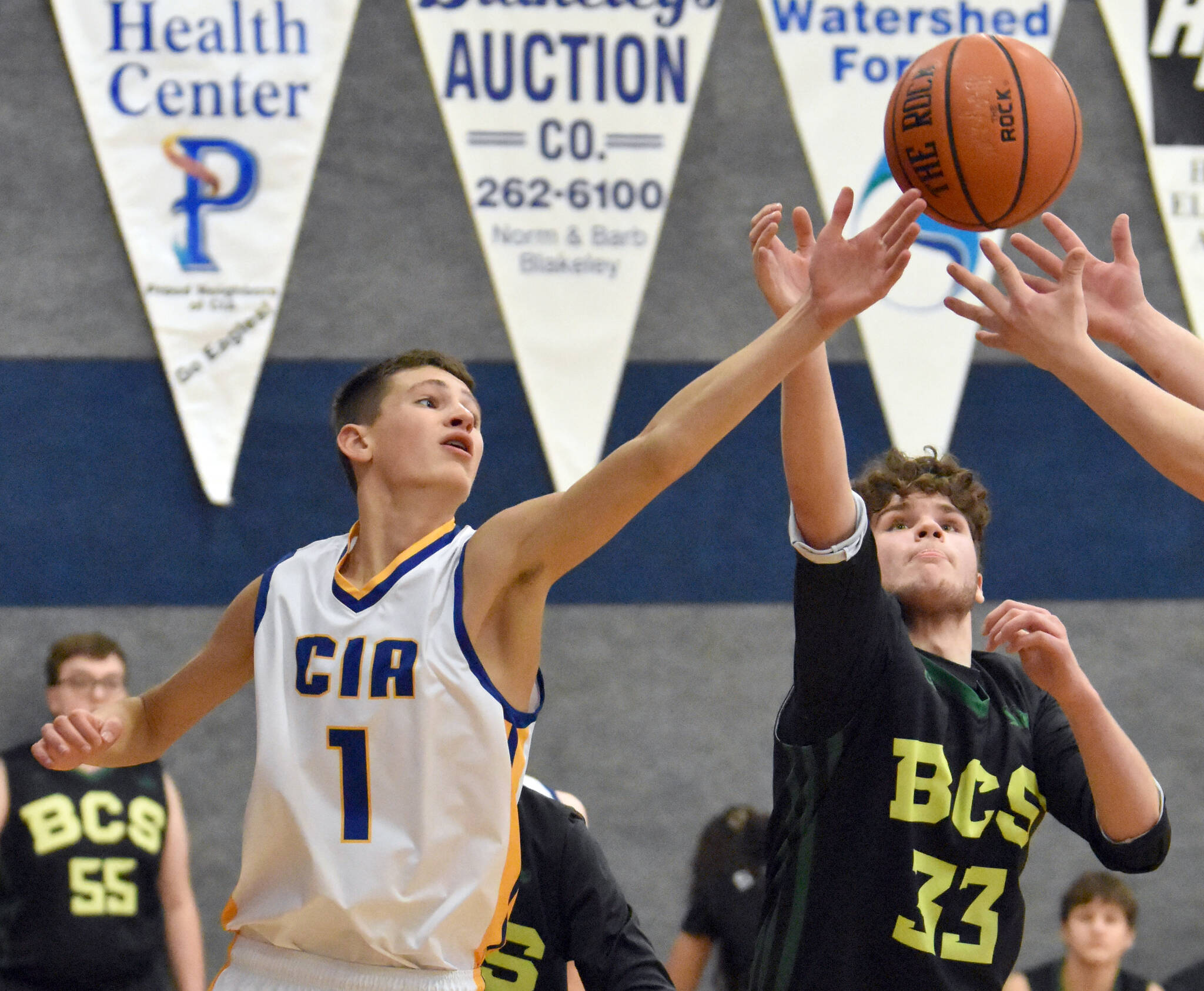 Cook Inlet Academy’s Alek McGarry battles for a rebound against Birchwood Christian on Saturday, Jan. 21, 2023, at Cook Inlet Academy just outside of Soldotna, Alaska. (Photo by Jeff Helminiak/Peninsula Clarion)