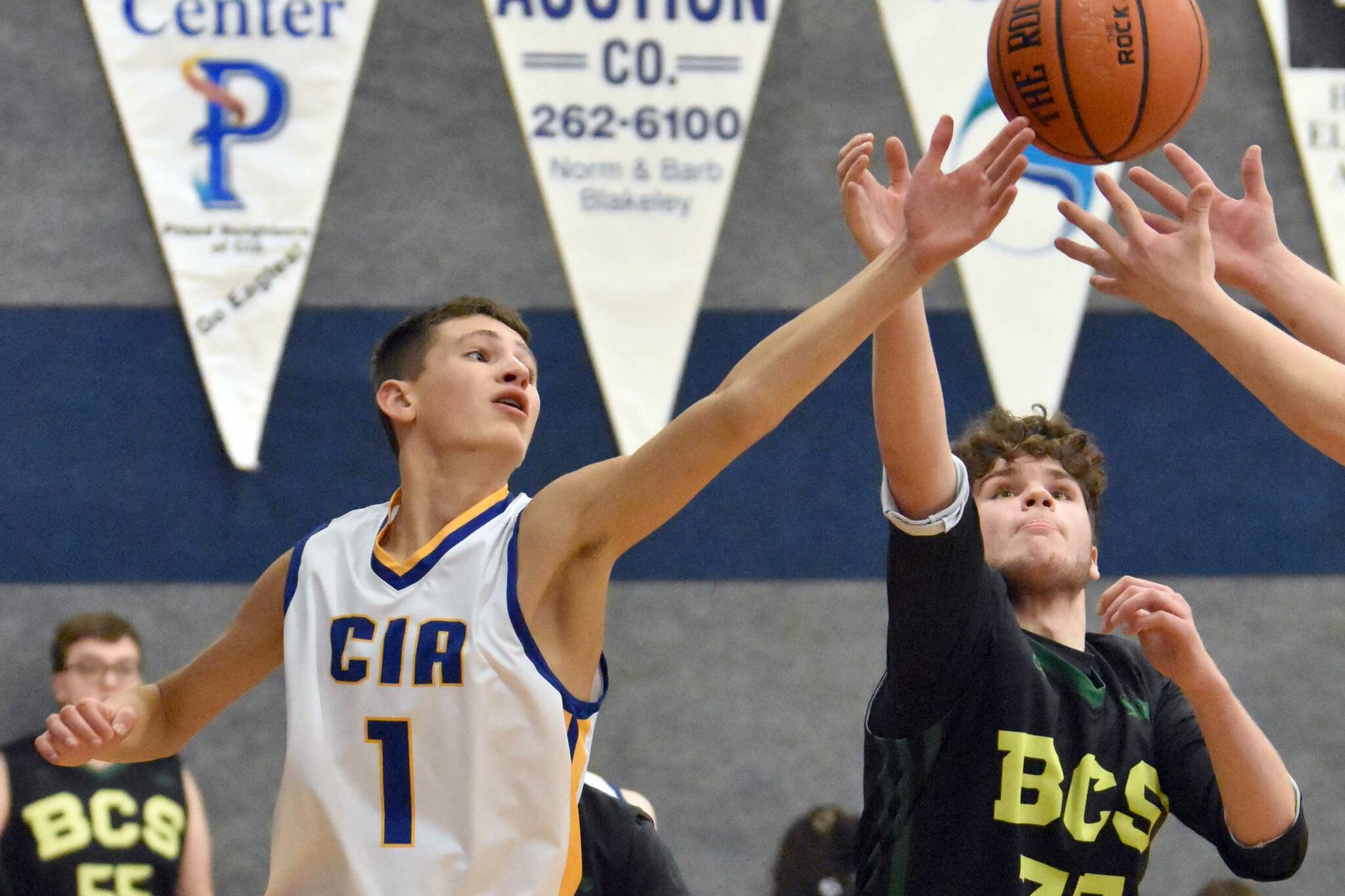 Cook Inlet Academy's Alek McGarry battles for a rebound against Birchwood Christian on Saturday, Jan. 21, 2023, at Cook Inlet Academy just outside of Soldotna, Alaska. (Photo by Jeff Helminiak/Peninsula Clarion)