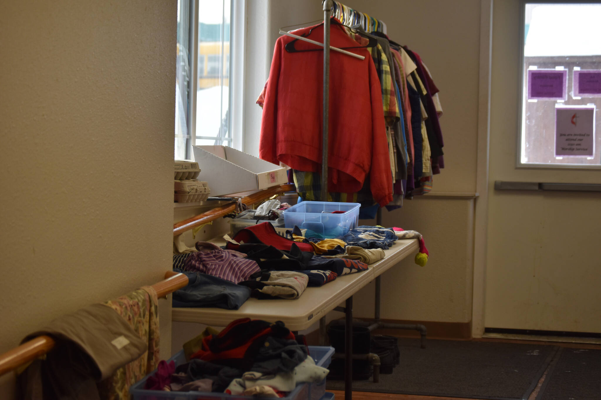 Donated clothes, including sweaters and gloves, are available for those in need at Kenai United Methodist Food Pantry in Kenai, Alaska, on Monday, Jan. 23, 2022. (Jake Dye/Peninsula Clarion)
