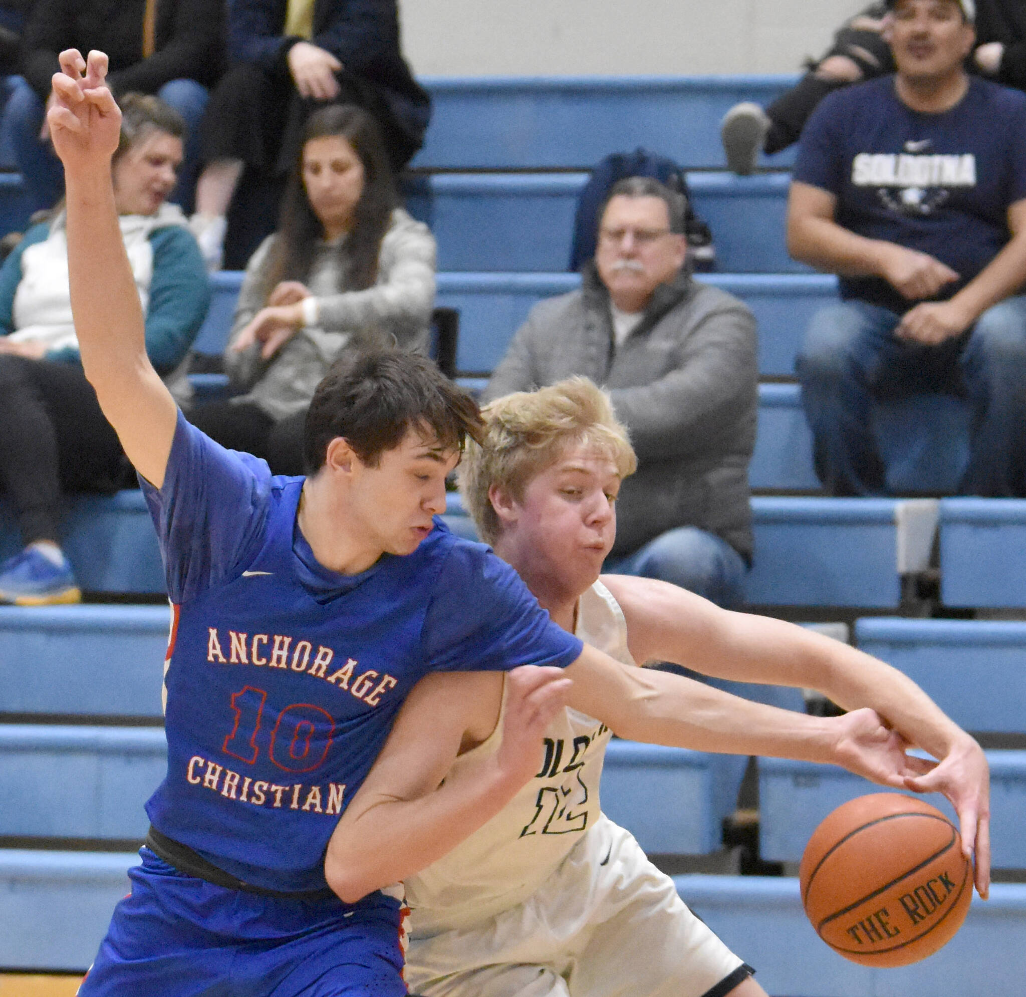 JD McGee of Anchorage Christian Schools knocks the ball away from Soldotna’s Jakob Brown on Wednesday, Jan. 25, 2023, at Soldotna High School in Soldotna, Alaska. (Photo by Jeff Helminiak/Peninsula Clarion)