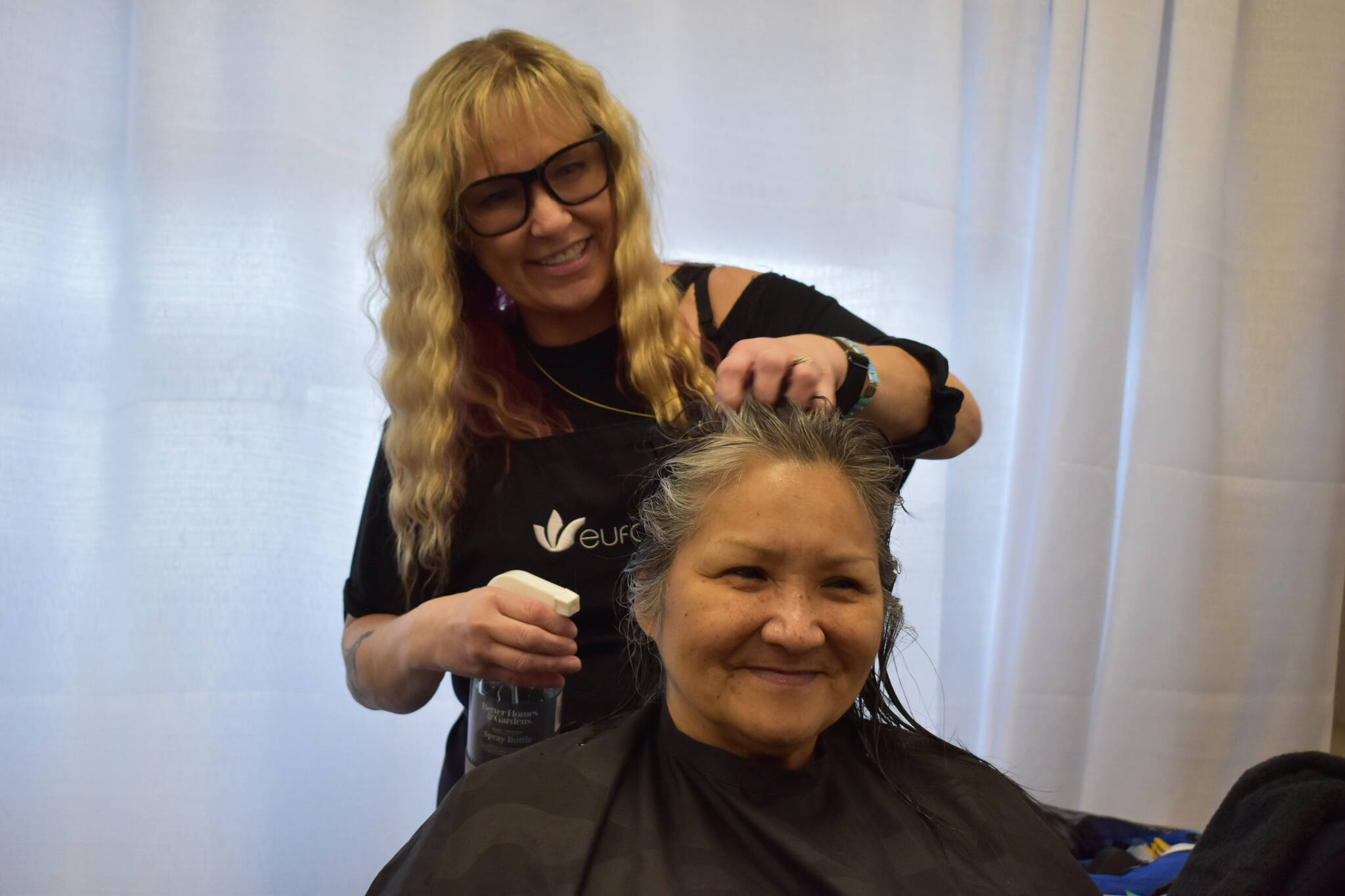Tamera Mapes gives a free haircut to a client during Project Homeless Connect on Tuesday, Jan. 31, 2023, at the Soldotna Regional Sports Complex in Soldotna, Alaska. (Jake Dye/Peninsula Clarion)