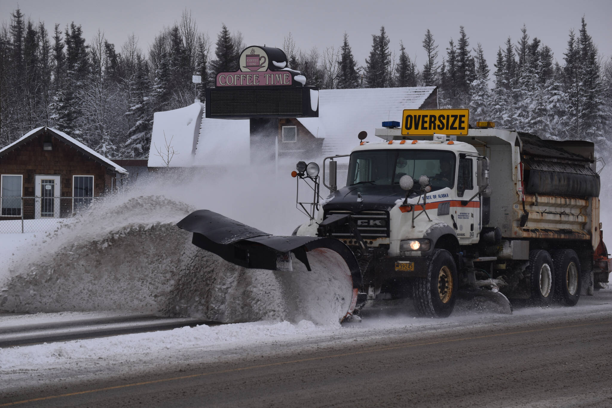 A plow truck clears snow from the Kenai Spur Highway on Wednesday, Nov. 2, 2022, in Kenai, Alaska. (Jake Dye/Peninsula Clarion)