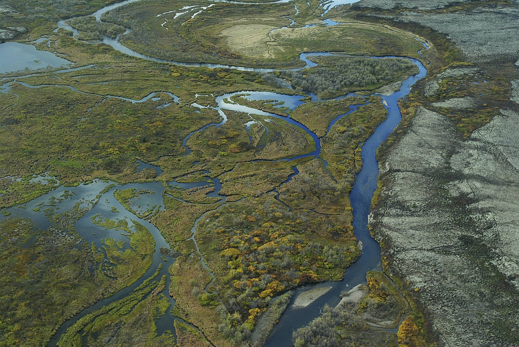 This September 2011 aerial photo provided by the Environmental Protection Agency, shows the Bristol Bay watershed in Alaska. The U.S. Environmental Protection Agency on Tuesday, Jan. 31, 2023, effectively vetoed a proposed copper and gold mine in the remote region of southwest Alaska that is coveted by mining interests but that also supports the world’s largest sockeye salmon fishery. (Joseph Ebersole/EPA via AP)
