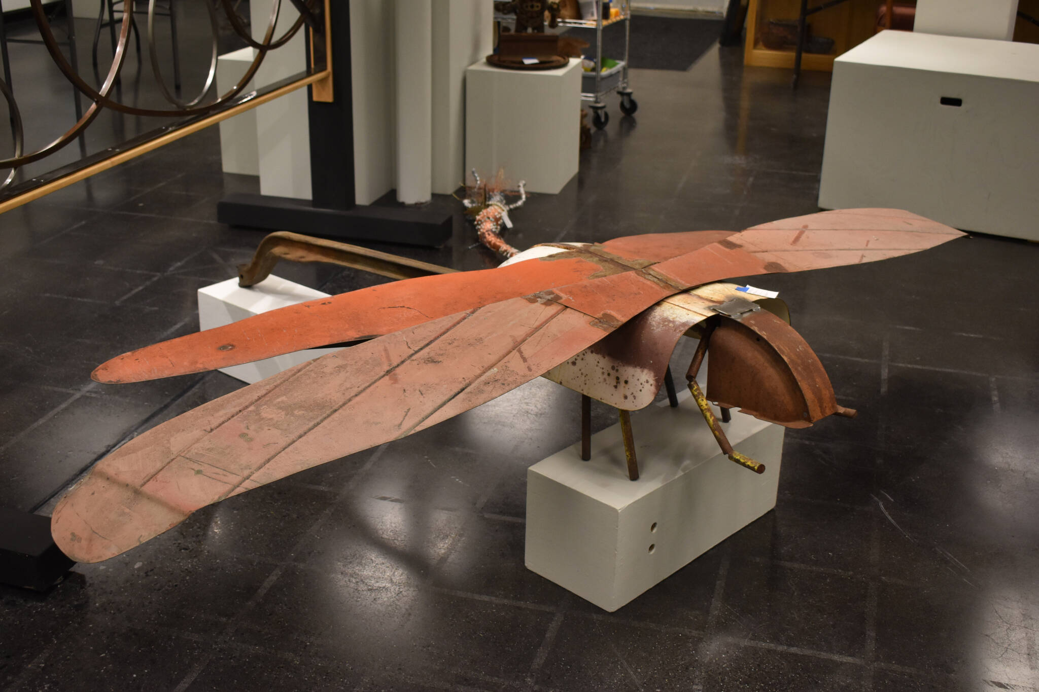 A large metal dragonfly sculpted by Jacob Nabholz commands a space on the floor Tuesday, Jan. 31, 2023, at the Kenai Art Center, in Kenai, Alaska, as part of Metalwork & Play. (Jake Dye/Peninsula Clarion)