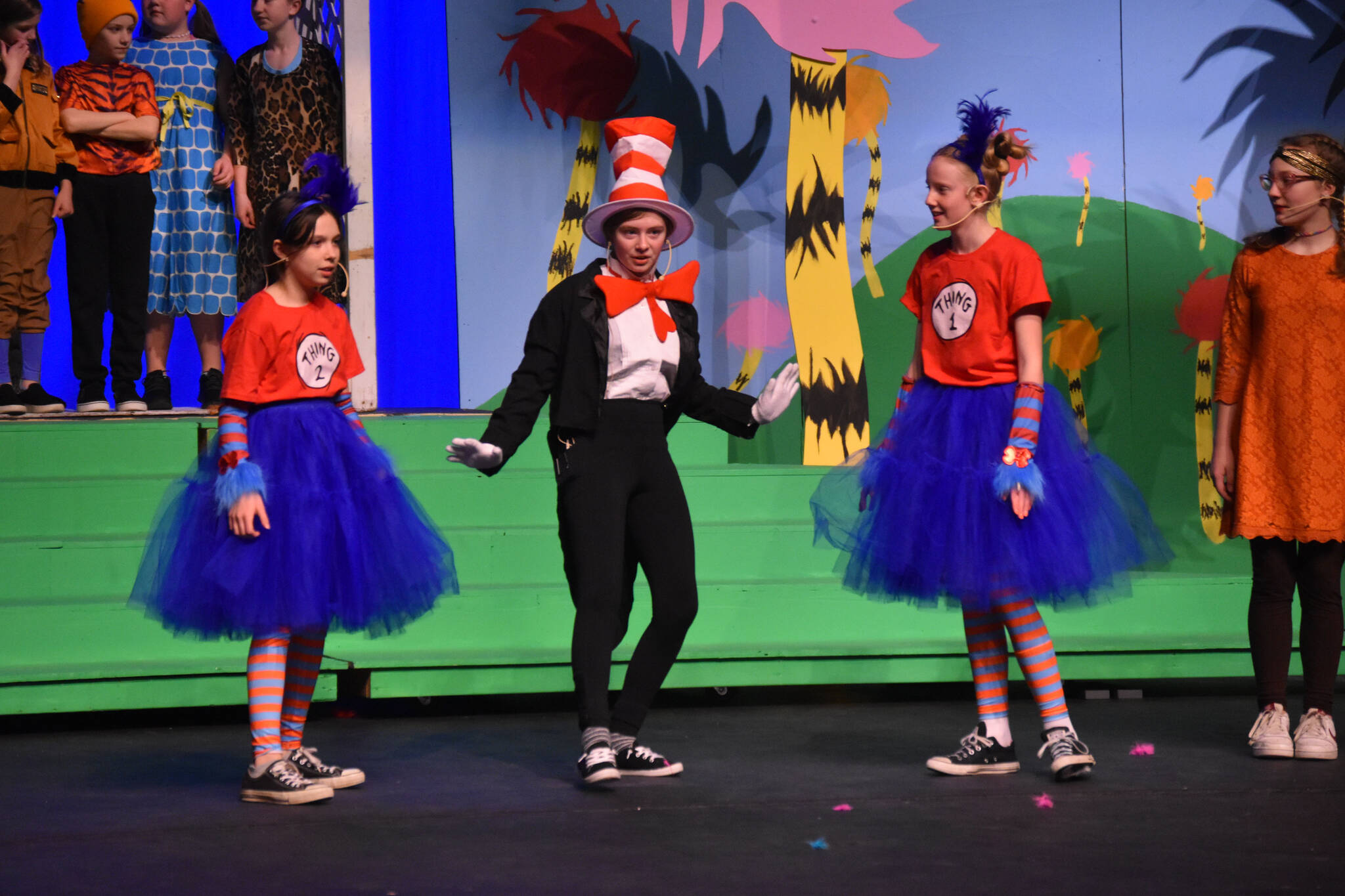 The cast of Triumvirate Theatre’s production of “Seussical,” portraying The Cat in the Hat, Thing 1 and Thing 2 rehearse on Wednesday, Feb. 8, 2023, in the Renee C. Henderson Auditorium at Kenai Central High School in Kenai, Alaska. (Jake Dye/Peninsula Clarion)