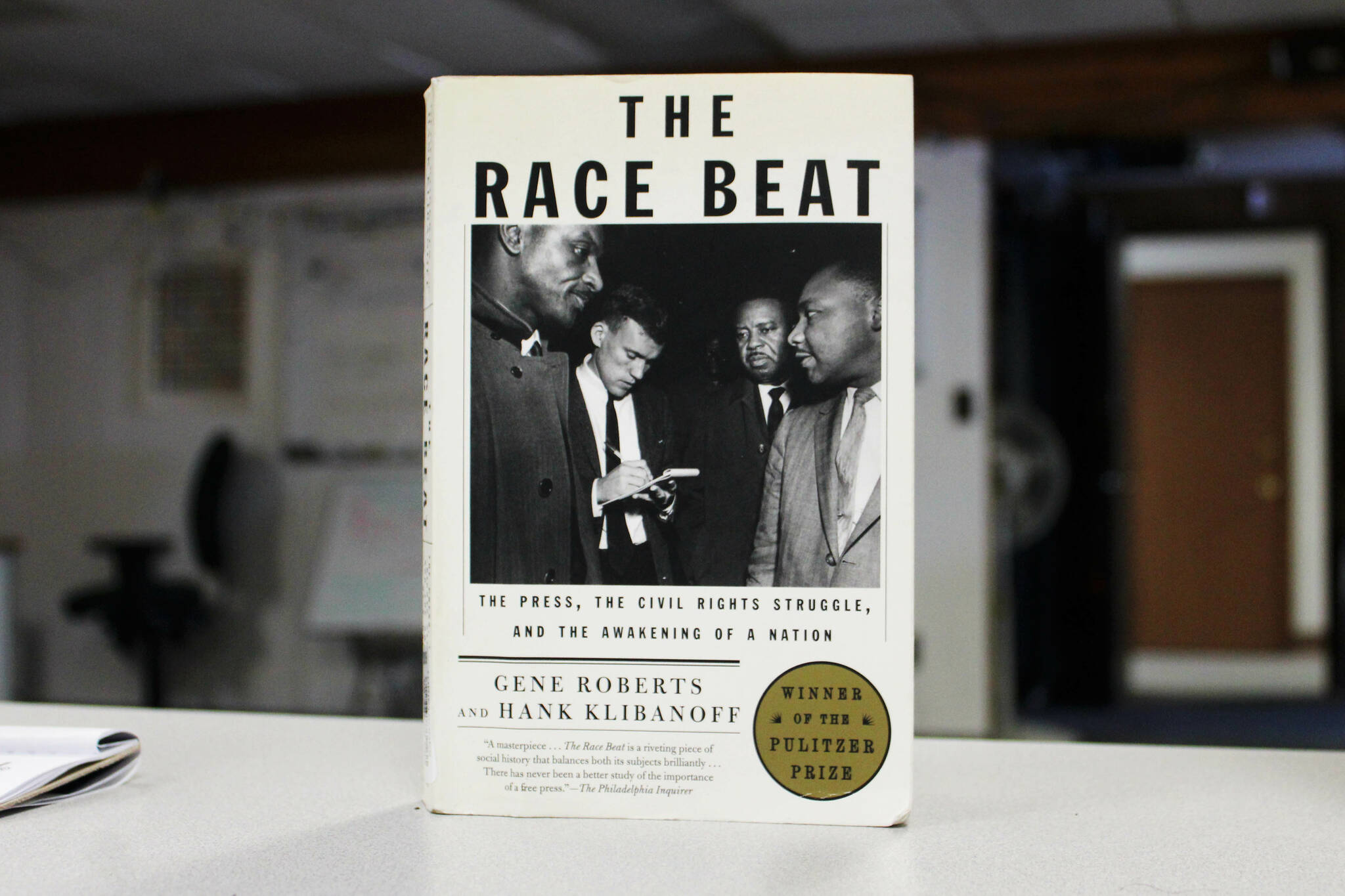 A copy of “The Race Beat: the Press, the Civil Rights Struggle, and the Awakening of a Nation” sits on a desk in the Peninsula Clarion office on Wednesday, Feb. 8, 2023, in Kenai, Alaska. (Ashlyn O’Hara/Peninsula Clarion)