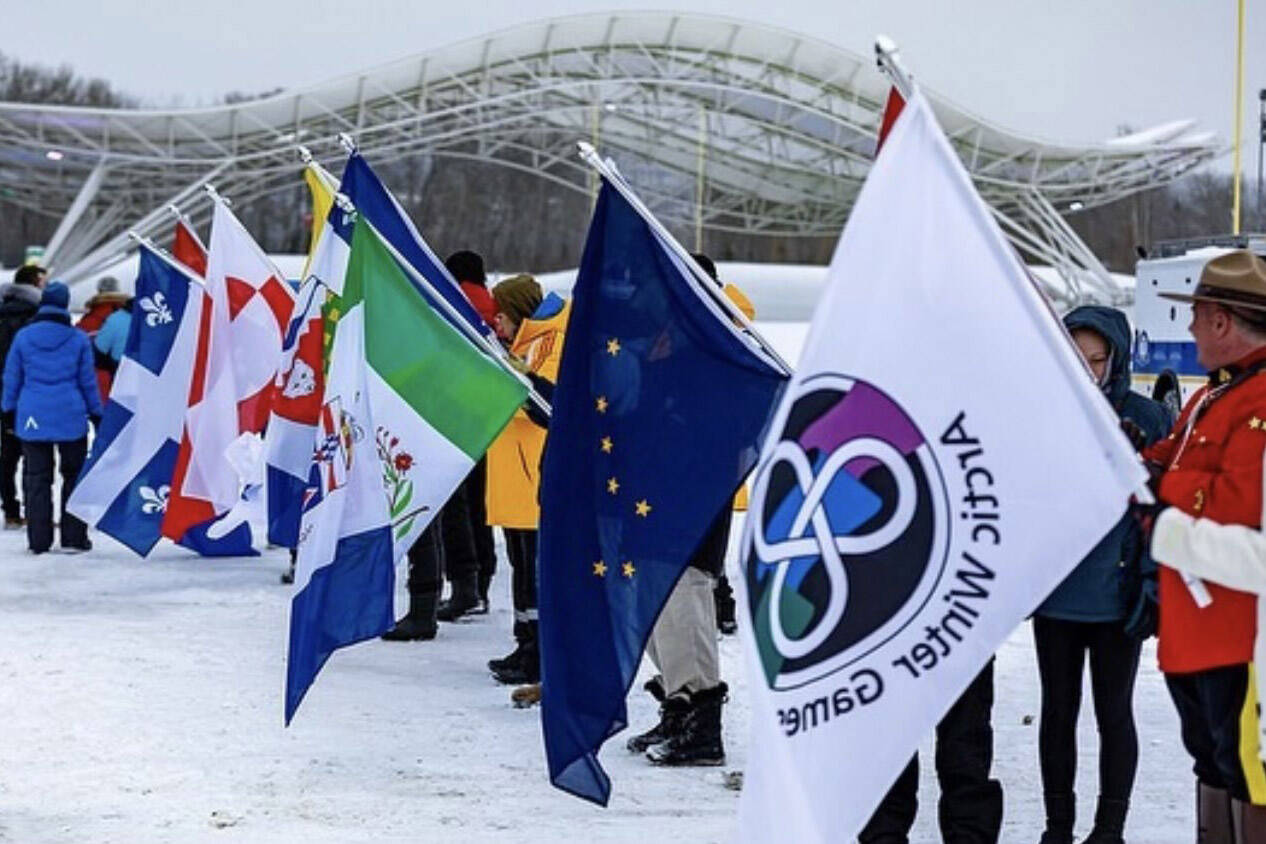 People hold flags of the participating teams of the 2023 Arctic Winter Games in this 2023 photo. (Photo provided by Matfey Reutov)